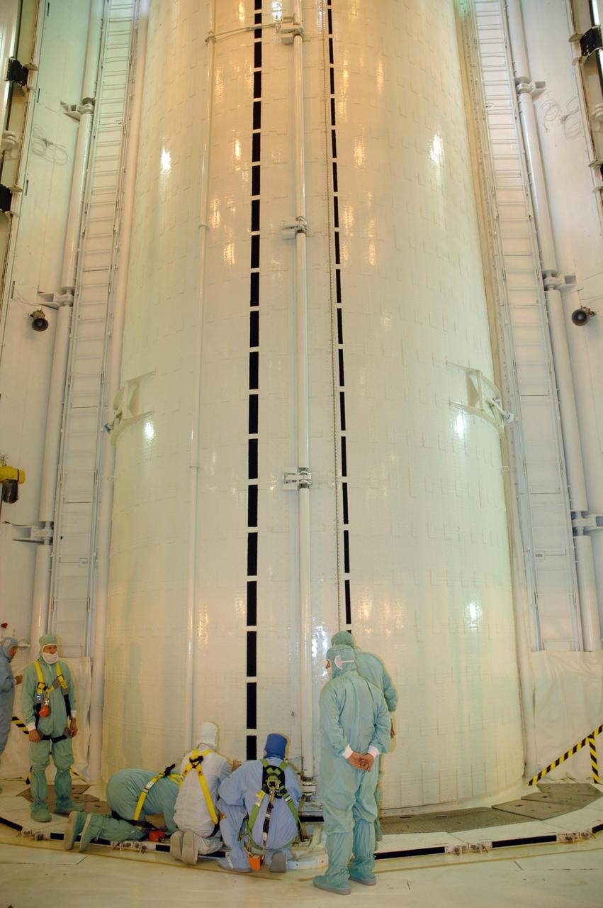 KENNEDY SPACE CENTER, FLA. --  In the payload changeout room (PCR) on Launch Pad 39A, workers prepare to open the canister containing the S3/S4 integrated truss.   The PCR is the enclosed, environmentally controlled portion of the rotating service structure that supports cargo delivery to the pad and subsequent vertical installation into the orbiter payload bay. The truss is the payload for Space Shuttle Atlantis on mission STS-117 to the International Space Station.  The Atlantis crew will install the new truss segment, retract a set of solar arrays and unfold a new set on the starboard side of the station. Launch is targeted for March 15. Photo credit: NASA/Jack Pfaller