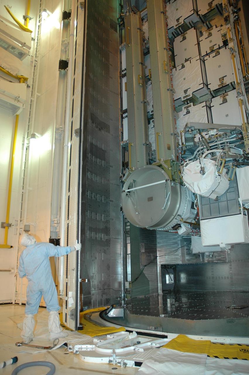 KENNEDY SPACE CENTER, FLA. -- In the payload changeout room (PCR) on Launch Pad 39A, the opening doors of the canister reveal the S3/S4 integrated truss inside. The PCR is the enclosed, environmentally controlled portion of the rotating service structure that supports cargo delivery to the pad and subsequent vertical installation into the orbiter payload bay. The truss is the payload for Space Shuttle Atlantis on mission STS-117 to the International Space Station.  The Atlantis crew will install the new truss segment, retract a set of solar arrays and unfold a new set on the starboard side of the station. Launch is targeted for March 15. Photo credit: NASA/Jack Pfaller