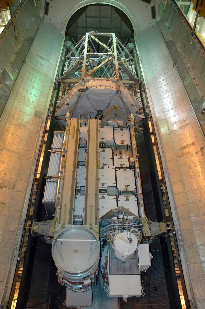 KENNEDY SPACE CENTER, FLA. -- In the payload changeout room (PCR) on Launch Pad 39A, the doors of the canister are opened to reveal the S3/S4 integrated truss inside.  The PCR is the enclosed, environmentally controlled portion of the rotating service structure that supports cargo delivery to the pad and subsequent vertical installation into the orbiter payload bay. The truss is the payload for Space Shuttle Atlantis on mission STS-117 to the International Space Station.  The Atlantis crew will install the new truss segment, retract a set of solar arrays and unfold a new set on the starboard side of the station. Launch is targeted for March 15. Photo credit: NASA/Jack Pfaller