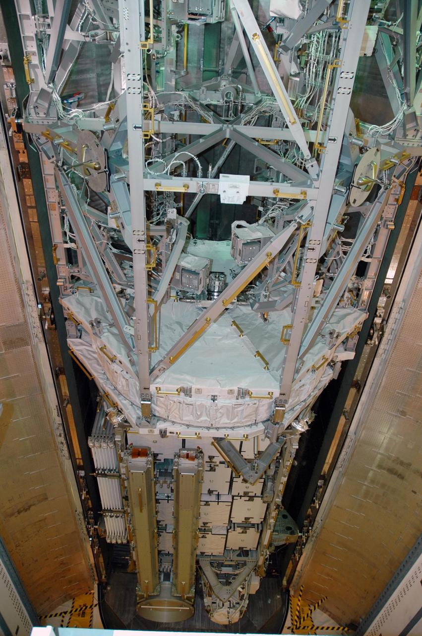 KENNEDY SPACE CENTER, FLA. --   In the payload changeout room (PCR) on Launch Pad 39A, the S3/S4 integrated truss is being moved out of the payload canister.  The PCR is the enclosed, environmentally controlled portion of the rotating service structure that supports cargo delivery to the pad and subsequent vertical installation into the orbiter payload bay. The truss is the payload for Space Shuttle Atlantis on mission STS-117 to the International Space Station.  The Atlantis crew will install the new truss segment, retract a set of solar arrays and unfold a new set on the starboard side of the station. Launch is targeted for March 15. Photo credit: NASA/Jack Pfaller