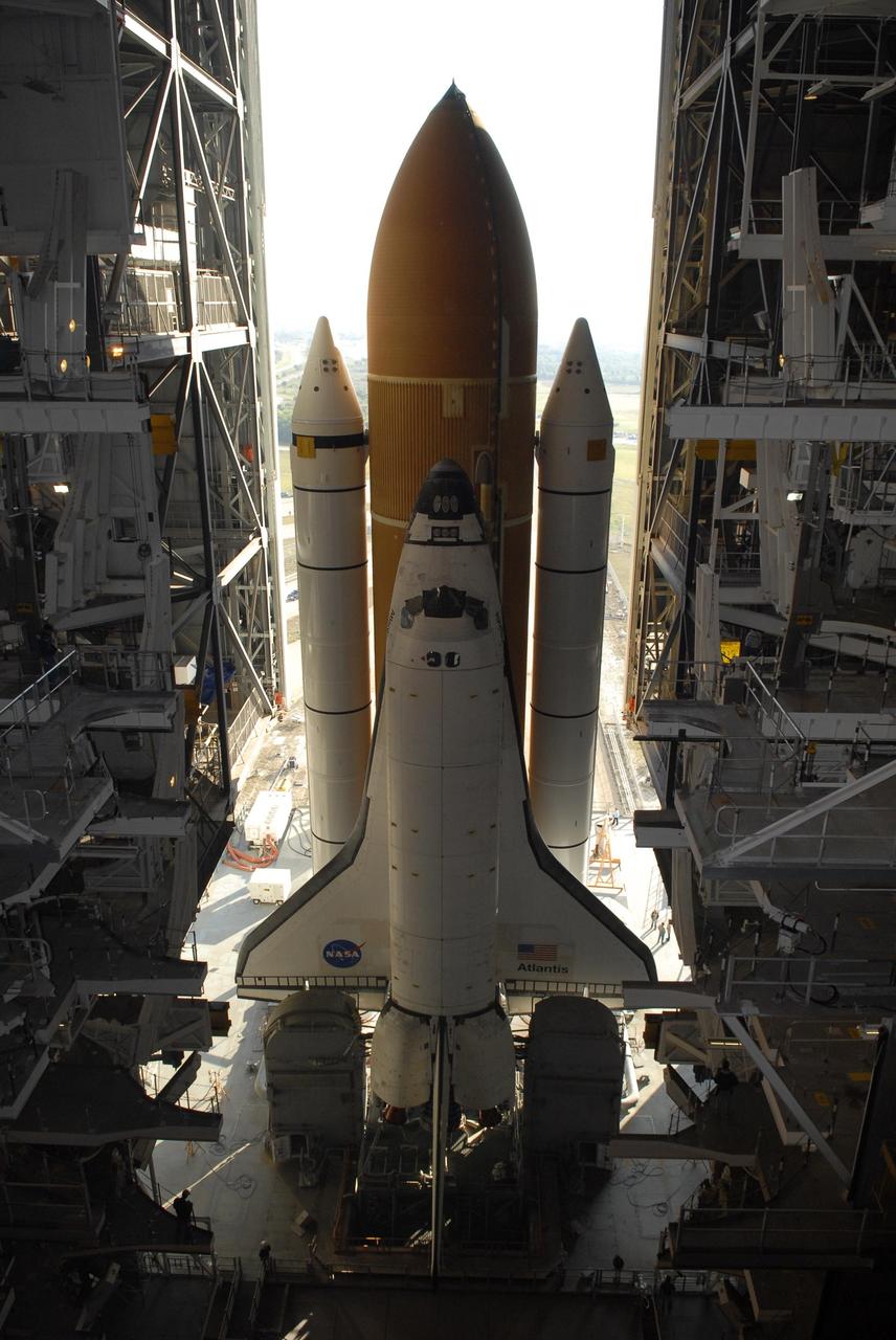 KENNEDY SPACE CENTER, FLA. -- Majestic in its formation, Space Shuttle Atlantis begins moving through the open door of the Vehicle Assembly Building for the rollout to Launch Pad 39A. First motion was at 8:19 a.m. The 3.4-mile trip along the crawlerway will take about 6 hours. The mission payload aboard Space Shuttle Atlantis is the S3/S4 integrated truss structure, along with a third set of solar arrays and batteries. The crew of six astronauts will install the truss to continue assembly of the International Space Station. Launch is targeted for March 15. Photo credit: NASA/Kim Shiflett
