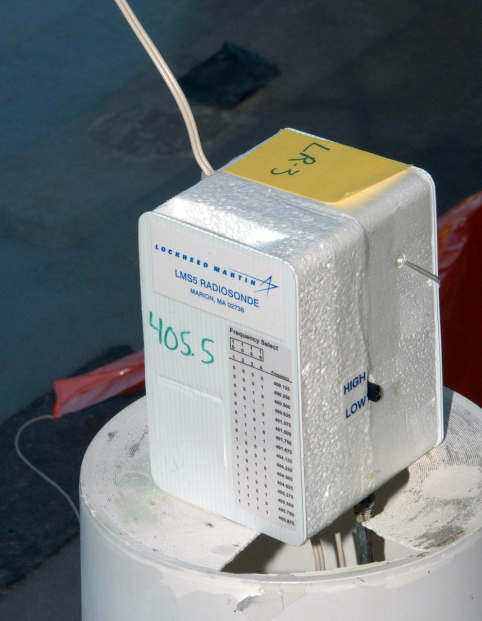 KENNEDY SPACE CENTER, FLA. -- A radiosonde, an instrument that transmits measurements on atmospheric pressure, humidity, temperature and winds, is prepared for use on a weather balloon at the Cape Canaveral Air Force Station weather station. The data it returns will be used to determine if conditions are acceptable for the launch of NASA's THEMIS mission. THEMIS, an acronym for Time History of Events and Macroscale Interactions during Substorms, consists of five identical probes that will track violent, colorful eruptions near the North Pole.  This will be the largest number of scientific satellites NASA has ever launched into orbit aboard a single rocket.  The THEMIS mission aims to unravel the mystery behind auroral substorms, an avalanche of magnetic energy powered by the solar wind that intensifies the northern and southern lights.  The mission will investigate what causes auroras in the Earth’s atmosphere to dramatically change from slowly shimmering waves of light to wildly shifting streaks of bright color. Launch is planned from Pad 17-B in a window that extends from 6:01 to 6:19 p.m. EST.  Photo credit: NASA/George Shelton