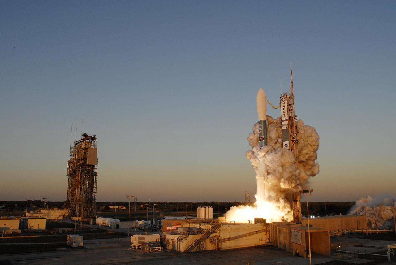 KENNEDY SPACE CENTER, FLA. -- Clouds of smoke encompass the Delta II rocket with NASA's THEMIS spacecraft aboard as it blasts off Pad 17-B at Cape Canaveral Air Force Station at 6:01 p.m. EST. THEMIS, an acronym for Time History of Events and Macroscale Interactions during Substorms, consists of five identical probes that will track violent, colorful eruptions near the North Pole.  This will be the largest number of scientific satellites NASA has ever launched into orbit aboard a single rocket.  The THEMIS mission aims to unravel the mystery behind auroral substorms, an avalanche of magnetic energy powered by the solar wind that intensifies the northern and southern lights.  The mission will investigate what causes auroras in the Earth’s atmosphere to dramatically change from slowly shimmering waves of light to wildly shifting streaks of bright color. Photo credit: NASA/Sandra Joseph, Ralph Hernandez