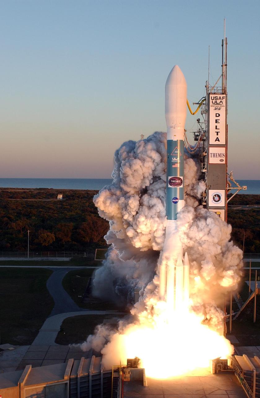 KENNEDY SPACE CENTER, FLA. -- At Cape Canaveral Air Force Station, clouds of smoke encompass the Delta II rocket with NASA's THEMIS spacecraft aboard as it blasts off Pad 17-B, in sight of the Atlantic Ocean, at 6:01 p.m. EST. THEMIS, an acronym for Time History of Events and Macroscale Interactions during Substorms, consists of five identical probes that will track violent, colorful eruptions near the North Pole.  This will be the largest number of scientific satellites NASA has ever launched into orbit aboard a single rocket.  The THEMIS mission aims to unravel the mystery behind auroral substorms, an avalanche of magnetic energy powered by the solar wind that intensifies the northern and southern lights.  The mission will investigate what causes auroras in the Earth’s atmosphere to dramatically change from slowly shimmering waves of light to wildly shifting streaks of bright color. Photo credit: NASA/Regina Mitchell-Ryall, Robert Murray, Tony Gray