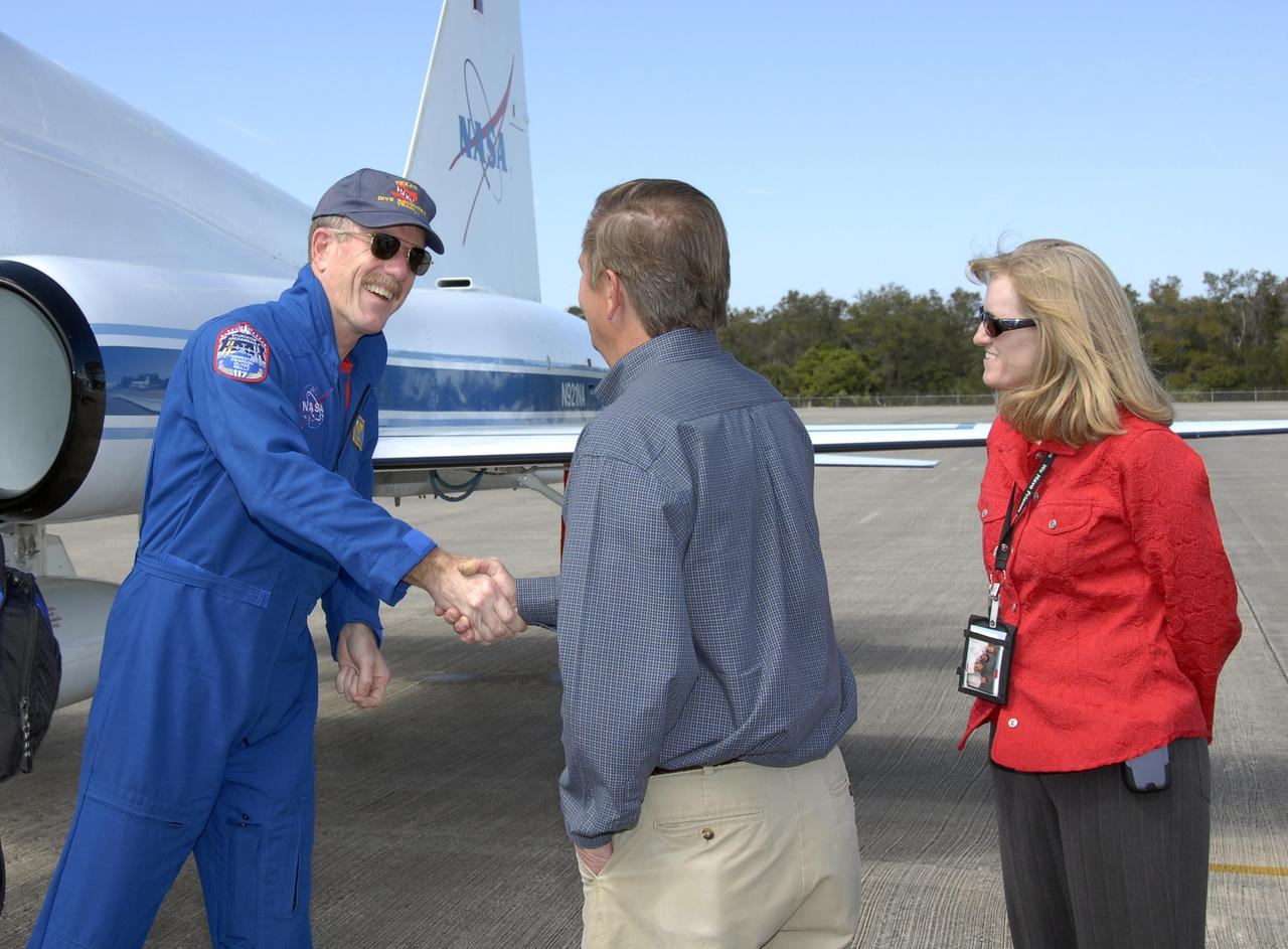 KENNEDY SPACE CENTER, FLA. -- The STS-117 crew arrives at NASA's Kennedy Space Center to take part in the Terminal Countdown Demonstration Test (TCDT), a preparation for the launch March 15 to the International Space Station. Mission Specialist James Reilly is greeted by NASA Launch Director Mike Leinbach and Atlantis (OV104) Flow Director Angela Brewer at the Shuttle Landing Facility. The TCDT includes emergency egress training and a simulated launch countdown. The mission payload aboard Space Shuttle Atlantis is the S3/S4 integrated truss structure, along with a third set of solar arrays and batteries. The crew of six astronauts will install the truss to continue assembly of the station. Photo credit: NASA/Kim Shiflett