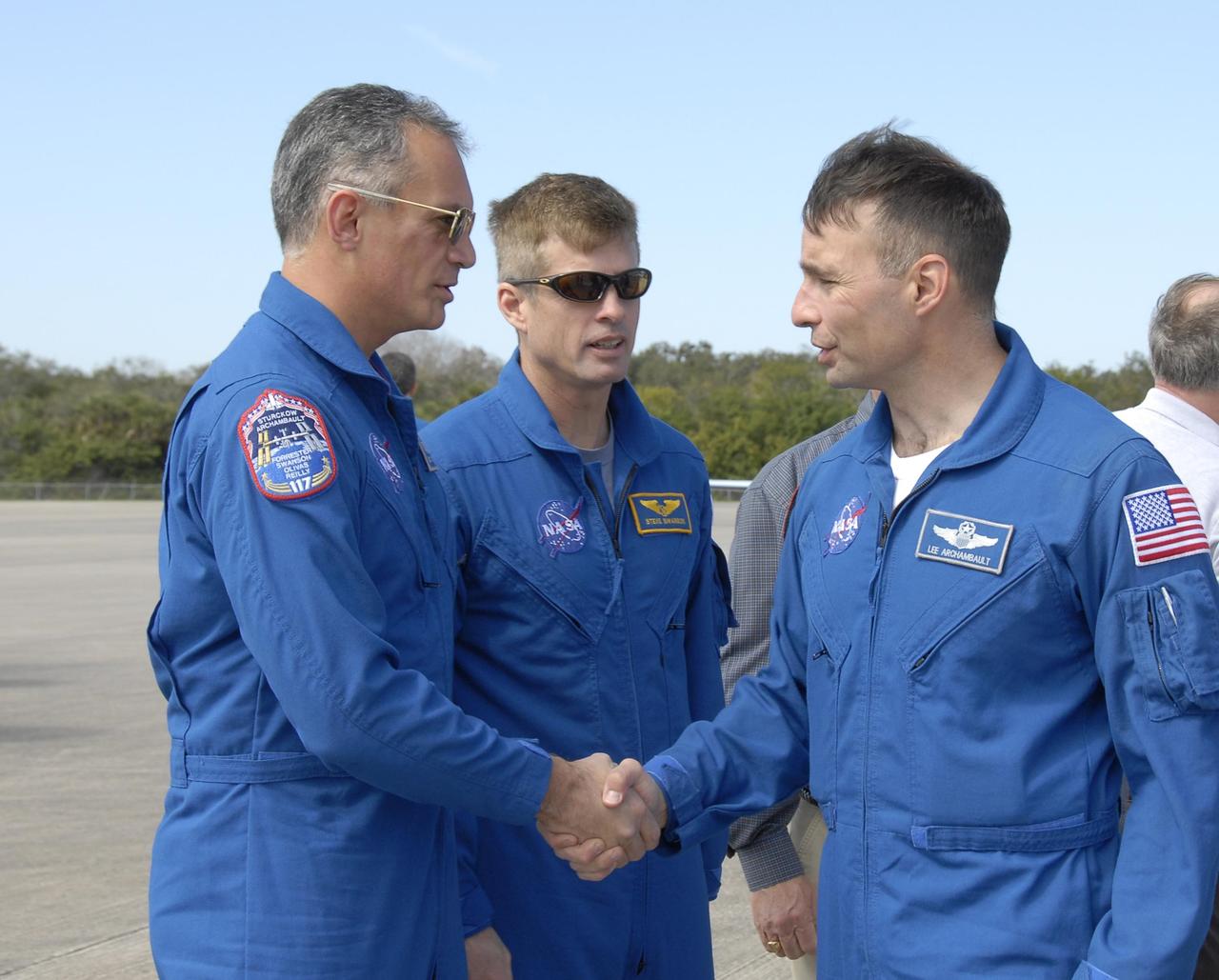 KENNEDY SPACE CENTER, FLA. -- The STS-117 crew arrives at NASA's Kennedy Space Center to take part in the Terminal Countdown Demonstration Test (TCDT), a preparation for the launch March 15 to the International Space Station. Arriving at the Shuttle Landing Facility are (from left) Mission Specialists Danny Olivas and Steven Swanson and Pilot Lee Archambault. The TCDT includes emergency egress training and a simulated launch countdown. The mission payload aboard Space Shuttle Atlantis is the S3/S4 integrated truss structure, along with a third set of solar arrays and batteries. The crew of six astronauts will install the truss to continue assembly of the station.  Photo credit: NASA/Kim Shiflett