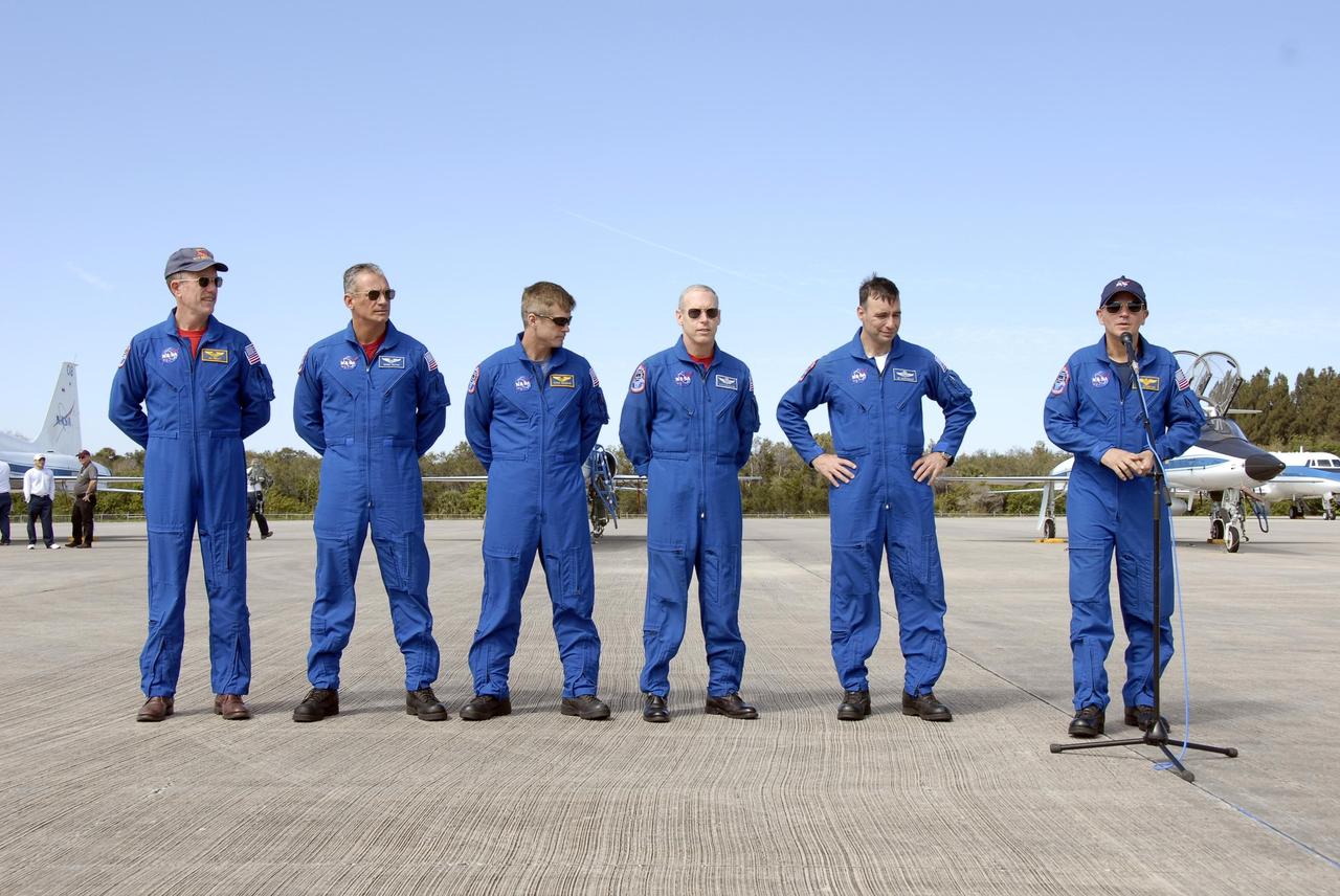 KENNEDY SPACE CENTER, FLA. -- The STS-117 crew arrives at NASA's Kennedy Space Center to take part in the Terminal Countdown Demonstration Test (TCDT), a preparation for the launch March 15 to the International Space Station. Commander Rick Sturckow, at the microphone, speaks to the media. With him, from the left, are Mission Specialists James Reilly, Danny Olivas, Steven Swanson and Patrick Forrester, and Pilot Lee Archambault. The TCDT includes emergency egress training and a simulated launch countdown. The mission payload aboard Space Shuttle Atlantis is the S3/S4 integrated truss structure, along with a third set of solar arrays and batteries. The crew of six astronauts will install the truss to continue assembly of the station. Photo credit: NASA/Kim Shiflett
