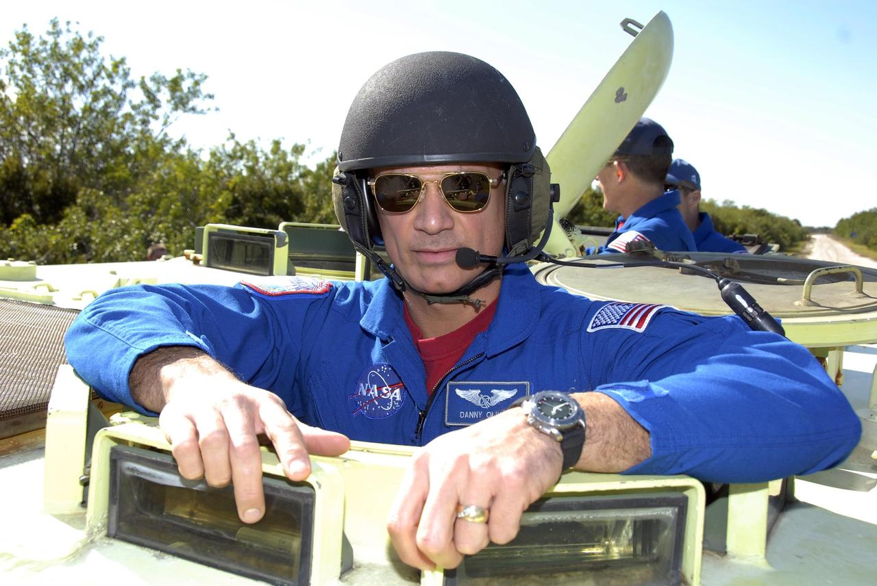 KENNEDY SPACE CENTER, FLA. -- At Launch Complex 39, STS-117 Mission Specialist Danny Olivas is helmeted and ready to practice driving an M-113 armored personnel carrier. The astronauts on the STS-117 crew are participating in M-113 armored personnel carrier training during Terminal Countdown Demonstration Test (TCDT) activities, a dress rehearsal for their launch, targeted for March 15. The M-113 could be used to move the crew away from the launch pad quickly in the event of an emergency. The TCDT also includes pad emergency egress training and a simulated launch countdown. The mission payload aboard Space Shuttle Atlantis is the S3/S4 integrated truss structure, along with a third set of solar arrays and batteries. The crew of six astronauts will install the truss to continue assembly of the station. Photo credit: NASA/Kim Shiflett