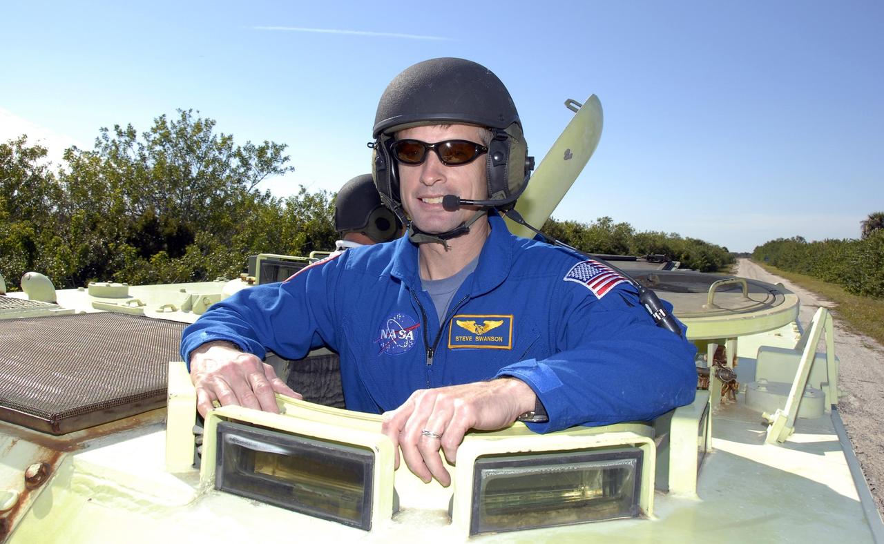 KENNEDY SPACE CENTER, FLA. -- At Launch Complex 39, STS-117 Mission Specialist Steven Swanson is helmeted and ready to practice driving an M-113 armored personnel carrier. The astronauts on the STS-117 crew are participating in M-113 armored personnel carrier training during Terminal Countdown Demonstration Test (TCDT) activities, a dress rehearsal for their launch, targeted for March 15. The M-113 could be used to move the crew away from the launch pad quickly in the event of an emergency. The TCDT also includes pad emergency egress training and a simulated launch countdown. The mission payload aboard Space Shuttle Atlantis is the S3/S4 integrated truss structure, along with a third set of solar arrays and batteries. The crew of six astronauts will install the truss to continue assembly of the station. Photo credit: NASA/Kim Shiflett