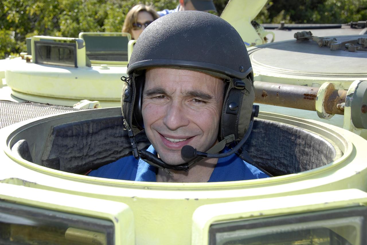 KENNEDY SPACE CENTER, FLA. -- At Launch Complex 39, STS-117 Pilot Lee Archambault is helmeted and ready to practice driving an M-113 armored personnel carrier. The astronauts on the STS-117 crew are participating in M-113 armored personnel carrier training during Terminal Countdown Demonstration Test (TCDT) activities, a dress rehearsal for their launch, targeted for March 15. The M-113 could be used to move the crew away from the launch pad quickly in the event of an emergency. The TCDT also includes pad emergency egress training and a simulated launch countdown. The mission payload aboard Space Shuttle Atlantis is the S3/S4 integrated truss structure, along with a third set of solar arrays and batteries. The crew of six astronauts will install the truss to continue assembly of the station. Photo credit: NASA/Kim Shiflett