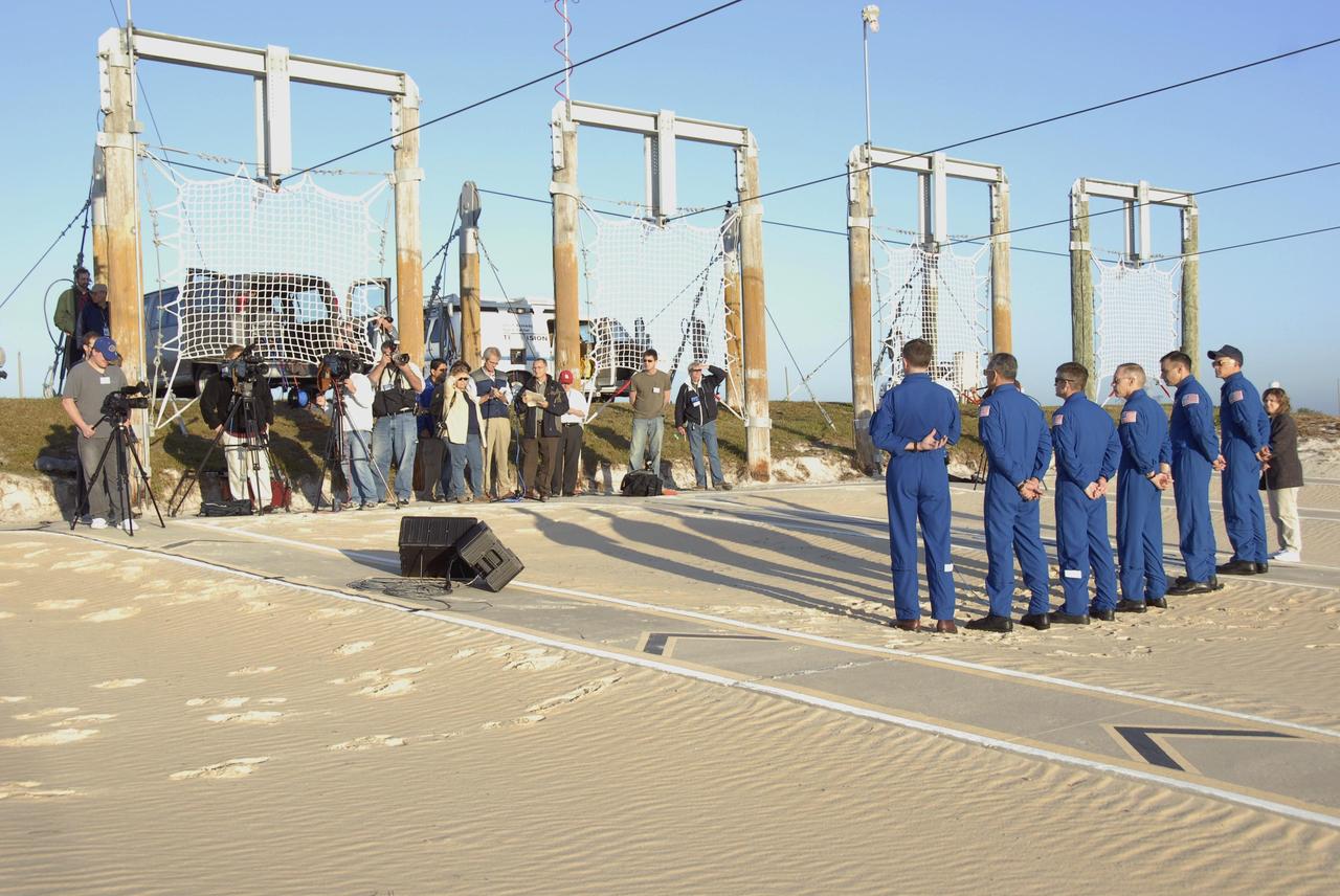 KENNEDY SPACE CENTER, FLA. -- During Terminal Countdown Demonstration Test (TCDT) activities at Launch Pad 39A, the Mission STS-117 crew members speak to the media during a question-and-answer session. From the left are Mission Specialists James Reilly, Danny Olivas, Steven Swanson and Patrick Forrester, Pilot Lee Archambault and Commander Rick Sturckow, along with NASA Public Affairs Specialist Jessica Rye. The TCDT also includes M-113 armored personnel carrier training, pad emergency egress training and a simulated launch countdown. The mission payload aboard Space Shuttle Atlantis is the S3/S4 integrated truss structure, along with a third set of solar arrays and batteries. The crew of six astronauts will install the truss to continue assembly of the International Space Station. Photo credit: NASA/Kim Shiflett
