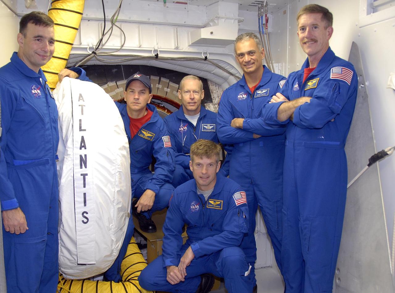 KENNEDY SPACE CENTER, FLA. --  During Terminal Countdown Demonstration Test activities, the Mission STS-117 crew members participate in an emergency egress walkdown at Launch Pad 39A. On the 195-foot level of the fixed service structure inside the white room are Mission Specialist Steven Swanson (kneeling), and standing from left, Pilot Lee Archambault, Commander Rick Sturckow, and Mission Specialists Patrick Forrester, Danny Olivas and James Reilly. The TCDT also includes M-113 armored personnel carrier training, and a simulated launch countdown. The mission payload aboard Space Shuttle Atlantis is the S3/S4 integrated truss structure, along with a third set of solar arrays and batteries. The crew of six astronauts will install the truss to continue assembly of the International Space Station. Photo credit: NASA/Kim Shiflett