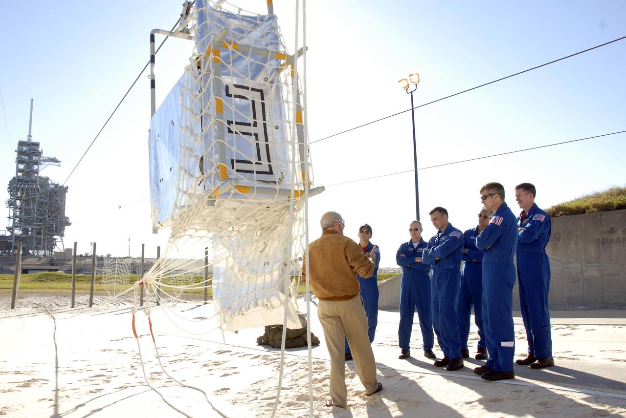 KENNEDY SPACE CENTER, FLA. --  In the Launch Pad 39A area, Mission STS-117 crew members receive instruction on emergency egress using the slidewire basket system during Terminal Countdown Demonstration Test activities. From left are Commander Rick Sturckow, Mission Specialist Patrick Forrester, Pilot Lee Archambault, and Mission Specialists Danny Olivas, Steven Swanson and James Reilly. The TCDT also includes M-113 armored personnel carrier training, and a simulated launch countdown. The mission payload aboard Space Shuttle Atlantis is the S3/S4 integrated truss structure, along with a third set of solar arrays and batteries. The crew of six astronauts will install the truss to continue assembly of the International Space Station. Photo credit: NASA/Kim Shiflett