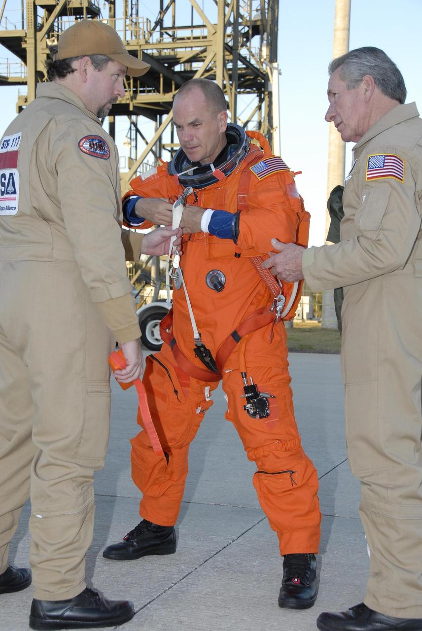 KENNEDY SPACE CENTER, FLA. --  Mission STS-117 Commander Rick Sturckow, dressed in his launch suit, prepares to begin practice flights on the shuttle training aircraft (STA) at the Shuttle Landing Facility during Terminal Countdown Demonstration Test (TCDT) activities. The STA is a Grumman American Aviation-built Gulf Stream II jet that was modified to simulate an orbiter's cockpit, motion and visual cues, and handling qualities. In flight, the STA duplicates the orbiter's atmospheric descent trajectory from approximately 35,000 feet altitude to landing on a runway. Because the orbiter is unpowered during re-entry and landing, its high-speed glide must be perfectly executed the first time. The mission payload aboard Space Shuttle Atlantis is the S3/S4 integrated truss structure, along with a third set of solar arrays and batteries. The crew of six astronauts will install the truss to continue assembly of the International Space Station.  STS-117 is the 118th space shuttle flight and the 21st flight to the station. Photo credit: NASA/Kim Shiflett