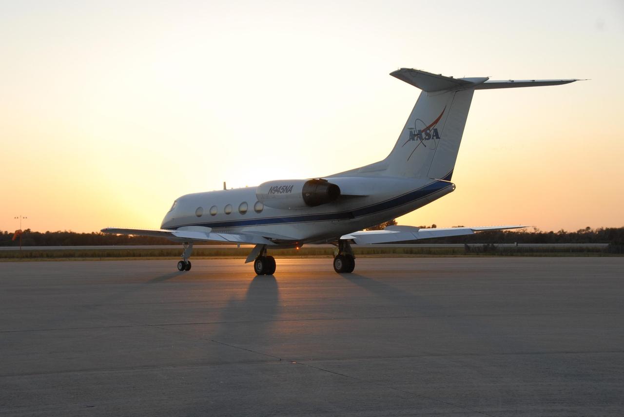KENNEDY SPACE CENTER, FLA. --  With the sun just peaking above the horizon, the shuttle training aircraft (STA) sits on the tarmac at the Shuttle Landing Facility, ready for practice flights by Mission STS-117 Commander Rick Sturckow and Pilot Lee Archambault. The STA is a Grumman American Aviation-built Gulf Stream II jet that was modified to simulate an orbiter's cockpit, motion and visual cues, and handling qualities. In flight, the STA duplicates the orbiter's atmospheric descent trajectory from approximately 35,000 feet altitude to landing on a runway. Because the orbiter is unpowered during re-entry and landing, its high-speed glide must be perfectly executed the first time. The mission payload aboard Space Shuttle Atlantis is the S3/S4 integrated truss structure, along with a third set of solar arrays and batteries. The crew of six astronauts will install the truss to continue assembly of the International Space Station.  STS-117 is the 118th space shuttle flight and the 21st flight to the station. Photo credit: NASA/Kim Shiflett