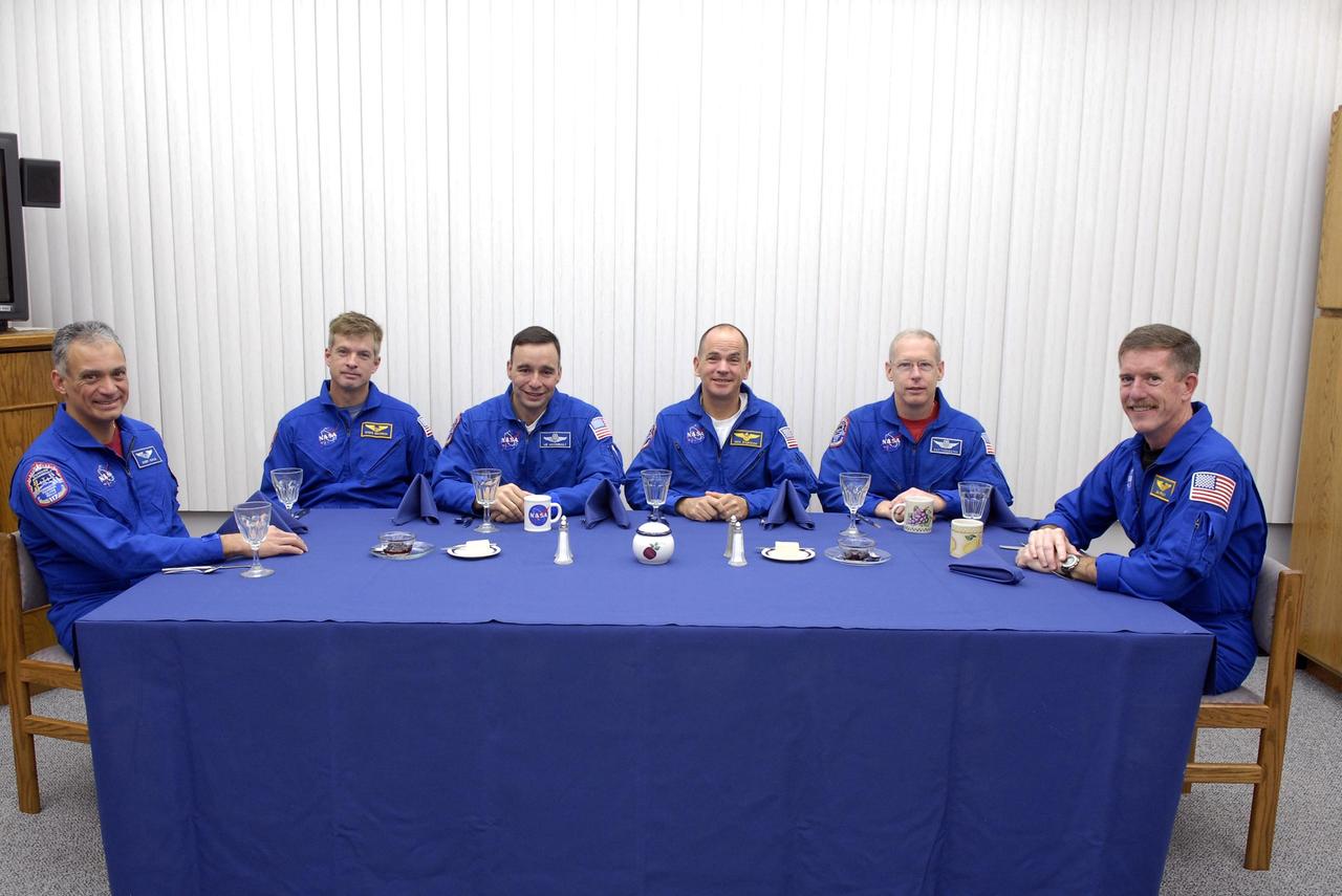 KENNEDY SPACE CENTER, FLA. -- In the crew quarters at the Operations and Checkout Building, the Mission STS-117 crew members enjoy breakfast before resuming Terminal Countdown Demonstration Test activities. From left are Mission Specialists Danny Olivas and Steven Swanson, Pilot Lee Archambault, Commander Rick Sturckow and Mission Specialists Patrick Forrester and James Reilly. The TCDT also includes M-113 armored personnel carrier training, pad emergency egress training and a simulated launch countdown. The mission payload aboard Space Shuttle Atlantis is the S3/S4 integrated truss structure, along with a third set of solar arrays and batteries. The crew of six astronauts will install the truss to continue assembly of the International Space Station. Photo credit: NASA/Kim Shiflett.