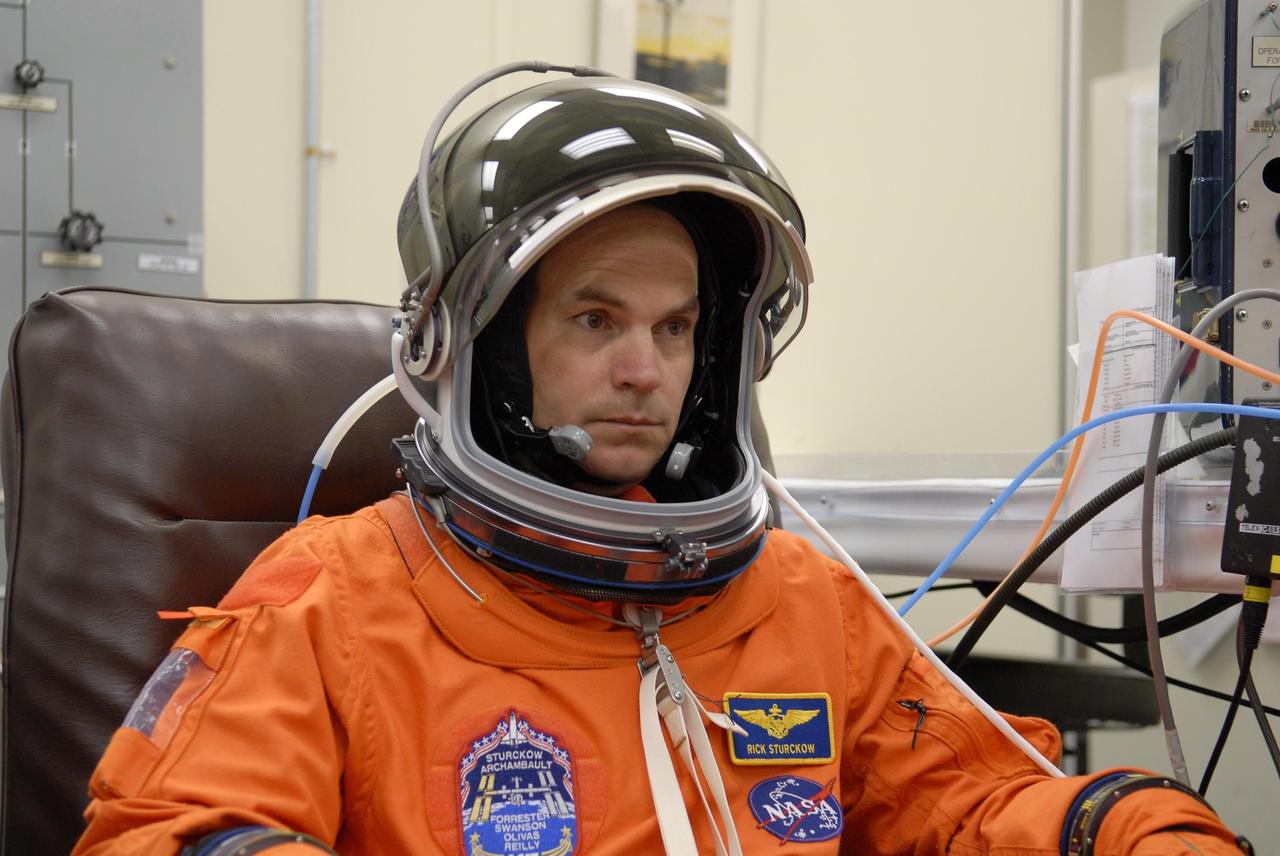 KENNEDY SPACE CENTER, FLA. -- Mission STS-117 Commander Rick Sturckow checks the fit of his launch suit and helmet, part of pre-launch preparations during terminal countdown demonstration test (TCDT) activities. The mission crew is at KSC for the TCDT, which includes a simulated launch countdown. The STS-117 mission is No. 21 to the International Space Station. Mission payloads aboard Atlantis include the S3/S4 integrated truss structure, a third set of solar arrays and batteries. The crew of six astronauts will install the truss to continue assembly of the station. Launch is scheduled for no earlier than March 15. Photo credit: NASA/Kim Shiflett.