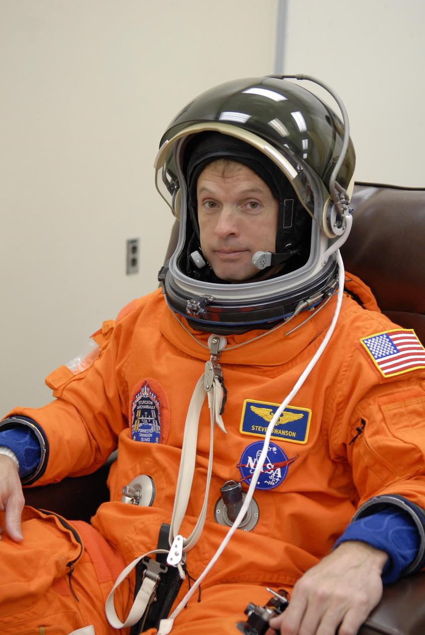 KENNEDY SPACE CENTER, FLA. -- Mission STS-117 Mission Specialist Steven Swanson checks the fit of his launch suit and helmet, part of pre-launch preparations during terminal countdown demonstration test (TCDT) activities. The mission crew is at KSC for the TCDT, which includes a simulated launch countdown. The STS-117 mission is No. 21 to the International Space Station. Mission payloads aboard Atlantis include the S3/S4 integrated truss structure, a third set of solar arrays and batteries. The crew of six astronauts will install the truss to continue assembly of the station. Launch is scheduled for no earlier than March 15. Photo credit: NASA/Kim Shiflett.