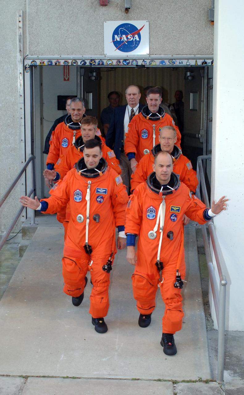 KENNEDY SPACE CENTER, FLA. -- Dressed in their flights suits, the Mission STS-117 crew members practice walk out from the Operations and Checkout Building to the astronaut van for transport to Launch Pad 39A during terminal countdown demonstration test activities. At left from the front are Pilot Lee Archambault and Mission Specialists Steven Swanson and Danny Olivas. At right from the front are Commander Rick Sturckow and Mission Specialists Patrick Forrester and James Reilly. The STS-117 mission is No. 21 to the International Space Station. Mission payloads aboard Atlantis include the S3/S4 integrated truss structure, a third set of solar arrays and batteries. The crew of six astronauts will install the truss to continue assembly of the station. Launch is scheduled for no earlier than March 15. Photo credit: NASA/Kim Shiflett.