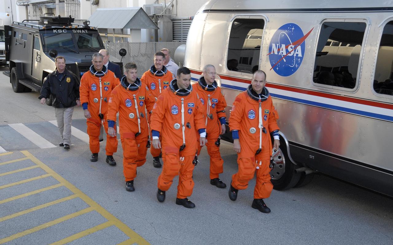 KENNEDY SPACE CENTER, FLA. -- Dressed in their flights suits, the Mission STS-117 crew members practice walk out from the Operations and Checkout Building to the astronaut van for transport to Launch Pad 39A during terminal countdown demonstration test activities. From the left are Mission Specialists Danny Olivas, Steven Swanson and James Reilly (behind Swanson), Pilot Lee Archambault, Mission Specialist Patrick Forrester, and Commander Rick Sturckow is leading the way. The STS-117 mission is No. 21 to the International Space Station. Mission payloads aboard Atlantis include the S3/S4 integrated truss structure, a third set of solar arrays and batteries. The crew of six astronauts will install the truss to continue assembly of the station. Launch is scheduled for no earlier than March 15. Photo credit: NASA/Kim Shiflett.