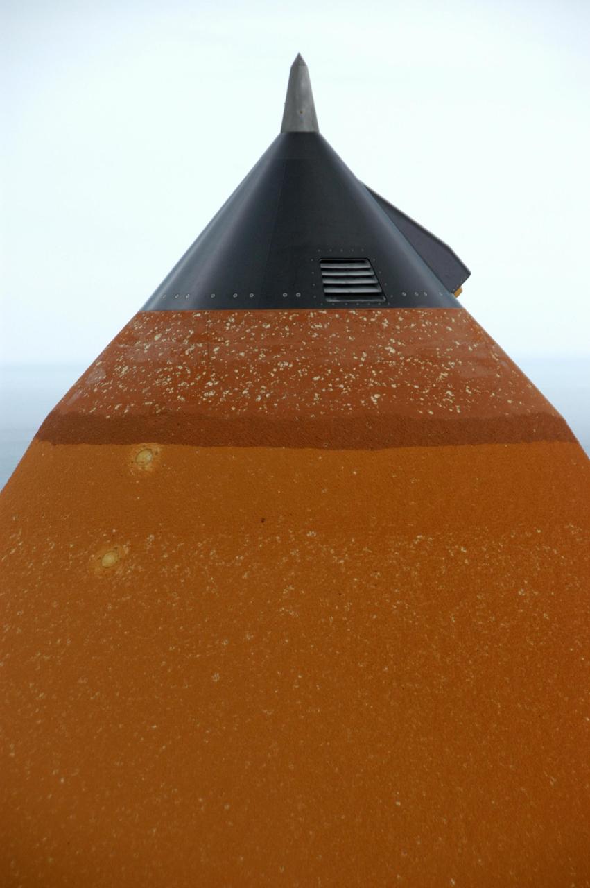 KENNEDY SPACE CENTER, FLA. --  At Launch Pad 39A, the external tank attached to Space Shuttle Atlantis shows damage from hail bombardment during a strong thunderstorm that passed through Kennedy Space Center about 5 p.m. EST on Feb. 26. A full assessment of the storm's impact is under way.  The two-day STS-117 Flight Readiness Review is being held concurrently with the assessment. Hail also impacted Space Shuttle Columbia before the launch of STS-4 in 1982; Atlantis, being readied for STS-38 in 1990; and Discovery, before the launch of STS-96 in 1999.