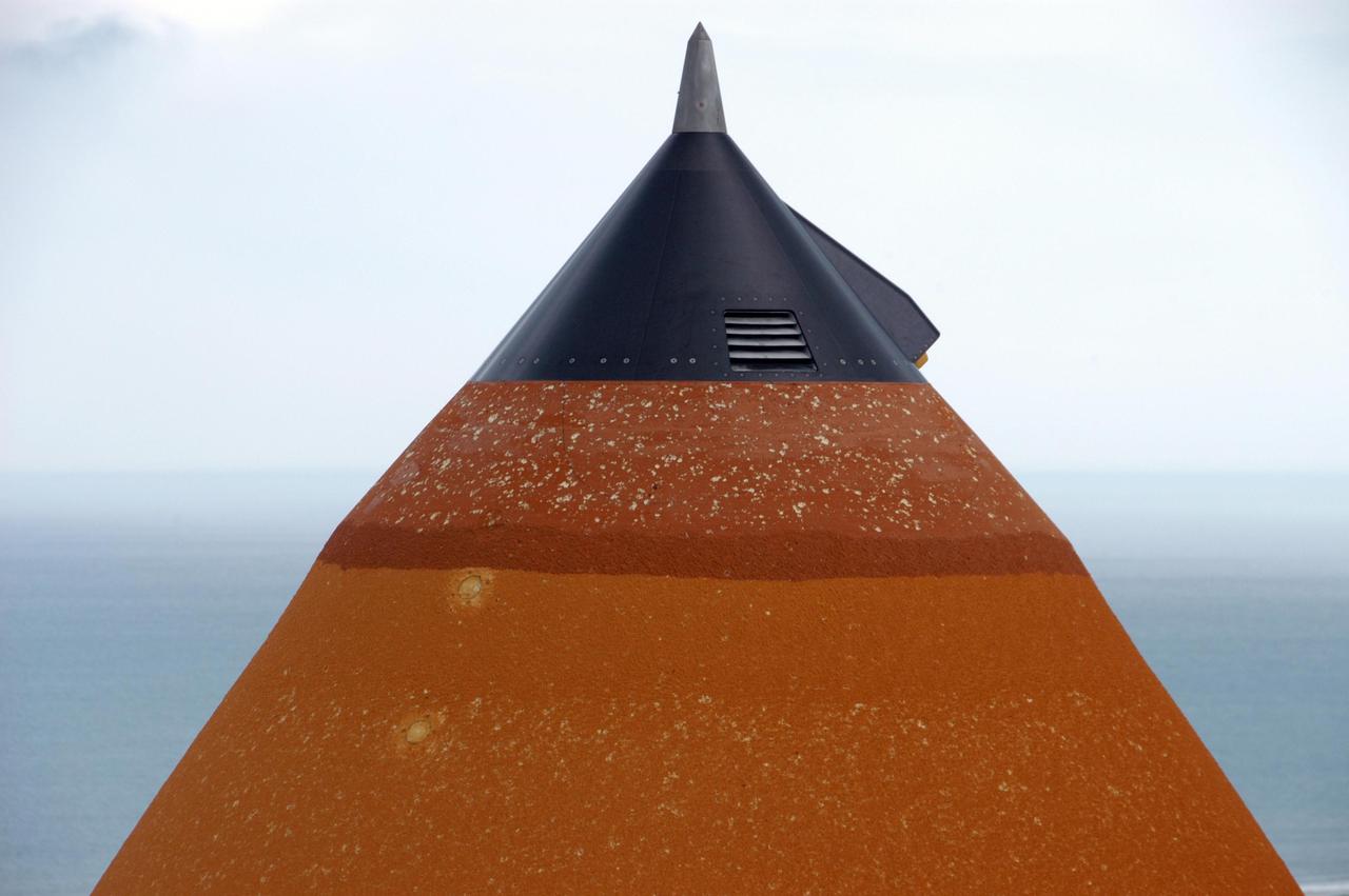 KENNEDY SPACE CENTER, FLA. --  At Launch Pad 39A, the external tank attached to Space Shuttle Atlantis shows damage from hail bombardment during a strong thunderstorm that passed through Kennedy Space Center about 5 p.m. EST on Feb. 26. A full assessment of the storm's impact is under way.  The two-day STS-117 Flight Readiness Review is being held concurrently with the assessment. Hail also impacted Space Shuttle Columbia before the launch of STS-4 in 1982; Atlantis, being readied for STS-38 in 1990; and Discovery, before the launch of STS-96 in 1999.