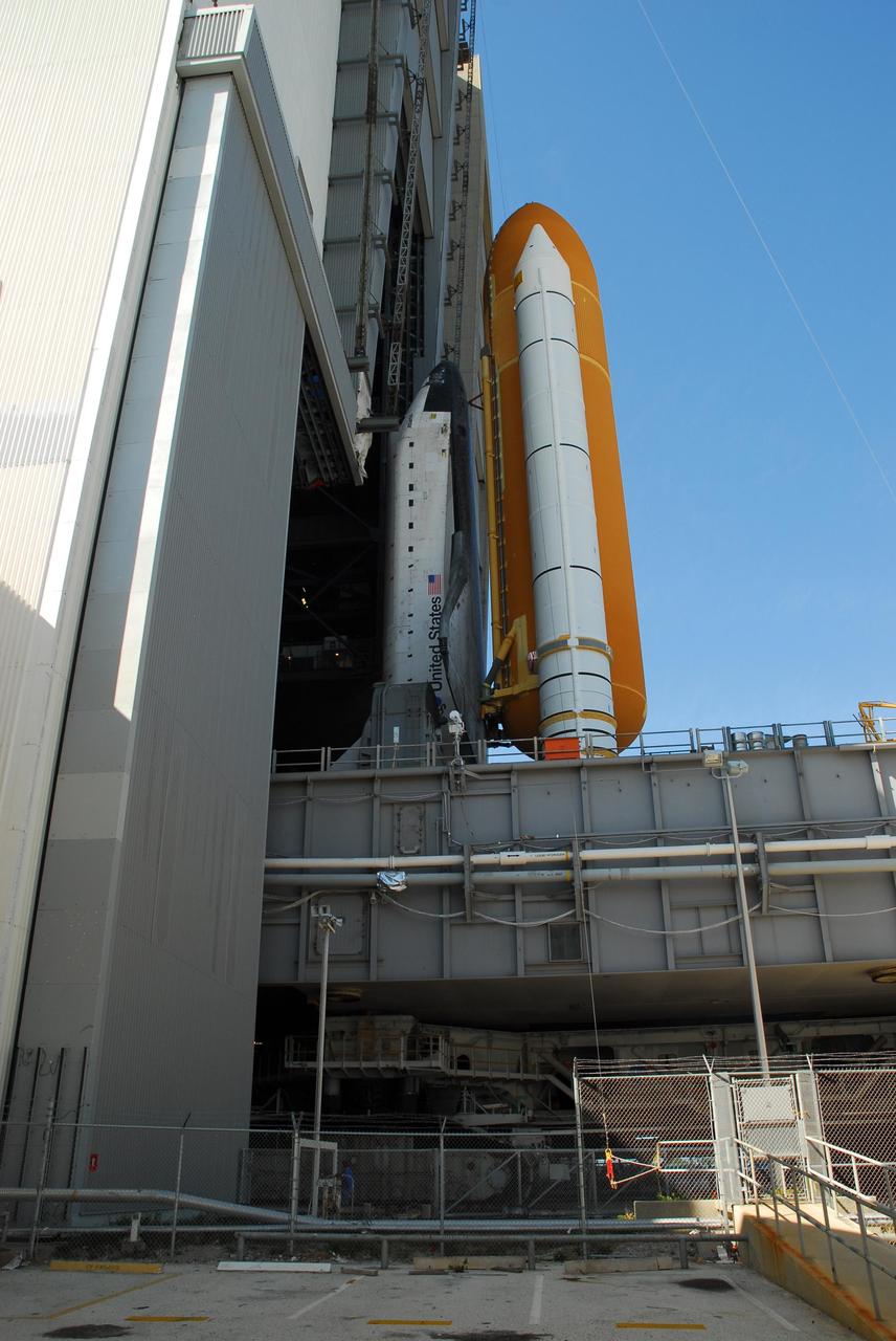 KENNEDY SPACE CENTER, FLA. --  Space Shuttle Atlantis, atop the mobile launcher platform, rolls through the door of high bay 1 of the Vehicle Assembly Building after leaving Launch Pad 39A. In the VAB, the shuttle will be examined for hail damage. A severe thunderstorm with golf ball-sized hail caused divots in the giant tank's foam insulation and minor surface damage to about 26 heat shield tiles on the shuttle's left wing. Further evaluation of the tank is necessary to get an accurate accounting of foam damage and determine the type of repair required and the time needed for that work.  A new target launch date has not been determined, but teams will focus on preparing Atlantis for liftoff in late April.  Photo credit: NASA/Amanda Diller