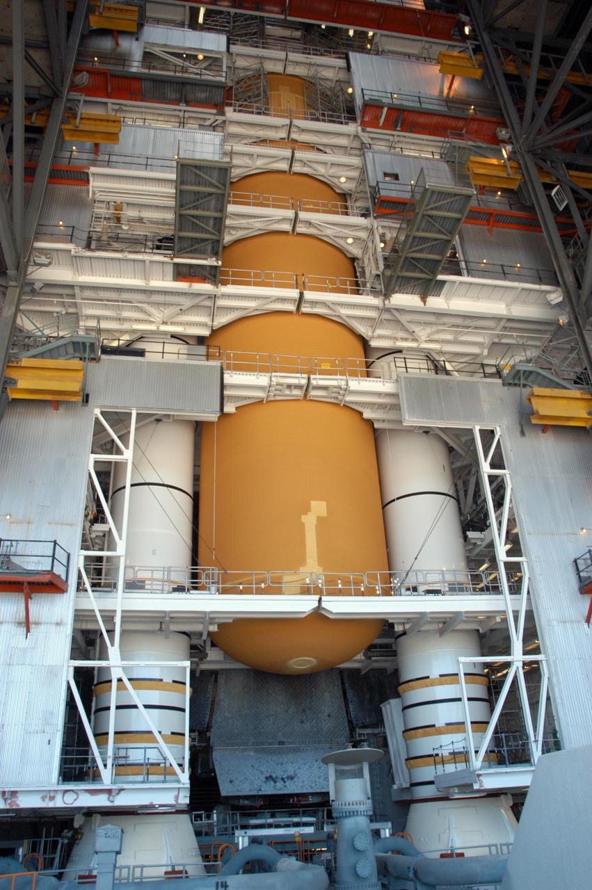 KENNEDY SPACE CENTER, FLA. -- In high bay 1 of the Vehicle Assembly Building, work is underway to repair the damage to Atlantis' external tank, seen here.  Technicians will prepare the nose cone for future work. A severe thunderstorm with golf ball-sized hail caused visible divots in the giant tank's foam insulation and minor surface damage to about 26 heat shield tiles on the shuttle's left wing. Further evaluation of the tank is necessary to get an accurate accounting of foam damage and determine the type of repair required and the time needed for that work. A new target launch date has not been determined, but teams will focus on preparing Atlantis for liftoff in late April on mission STS-117. Photo credit: NASA/George Shelton