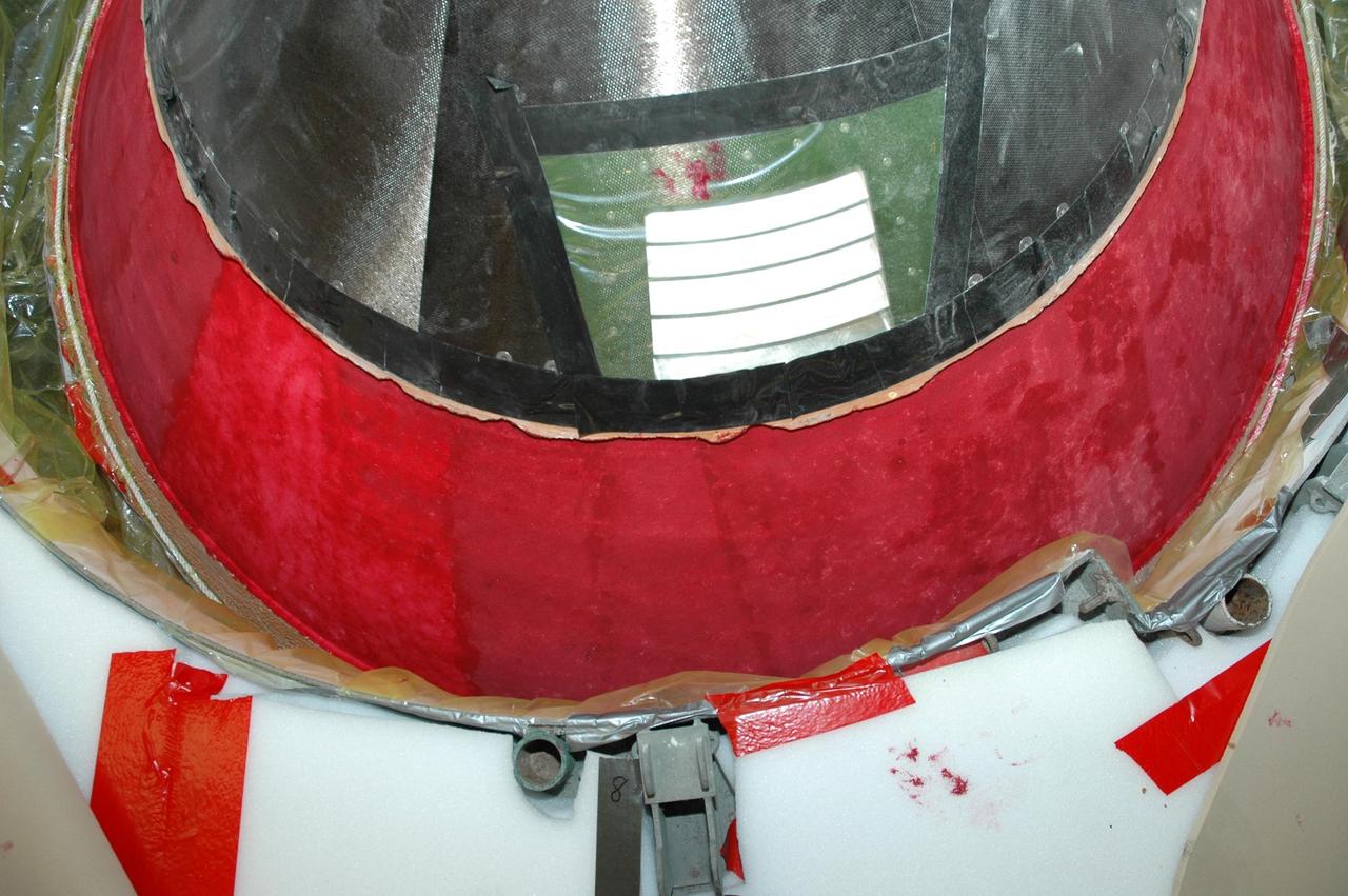 KENNEDY SPACE CENTER, FLA. -- In Highbay 1 inside the Vehicle Assembly Building, an area near the top of the external tank has been covered in a red dye to help expose cracks or compression dents.  A severe thunderstorm with golf ball-sized hail caused visible divots in the giant tank's foam insulation and minor surface damage to about 26 heat shield tiles on the shuttle's left wing. A new target launch date has not been determined, but teams will focus on preparing Atlantis for liftoff in late April on mission STS-117. Photo credit: NASA/Jim Grossmann