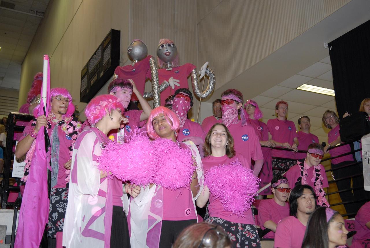 KENNEDY SPACE CENTER, FLA. --   The student team dressed in pink is a coordinated effort cosponsored by NASA KSC and representing Rockledge, Cocoa Beach and Viera High Schools in Central Florida.  The FIRST, or For Inspiration and Recognition of Science and Technology, Robotics Competition challenges teams of young people and their mentors to solve a common problem in a six-week timeframe using a standard "kit of parts" and a common set of rules. Teams build robots from the parts and enter them in a series of competitions designed by FIRST founder Dean Kamen and Dr. Woodie Flowers, chairman and vice chairman of the Executive Advisory Board respectively, and a committee of engineers and other professionals. FIRST redefines winning for these students. Teams are rewarded for excellence in design, demonstrated team spirit, gracious professionalism and maturity, and ability to overcome obstacles. Scoring the most points is a secondary goal. Winning means building partnerships that last. Photo credit: NASA/Kim Shiflett