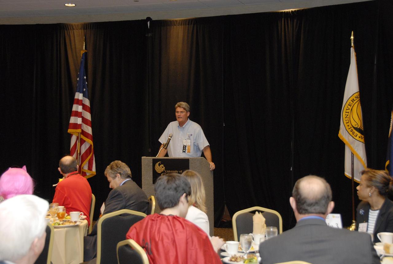 KENNEDY SPACE CENTER, FLA. --  Center Director Bill Parsons talks to guests at the VIP luncheon held during the FIRST robotics event held at the University of Central Florida Arena March 8-10.  This was Parsons' first year attending the event as center director.  An alumnus of UCF, Parsons also serves on the FIRST Executive Advisory Board.  The FIRST, or For Inspiration and Recognition of Science and Technology, Robotics Competition challenges teams of young people and their mentors to solve a common problem in a six-week timeframe using a standard "kit of parts" and a common set of rules. Teams build robots from the parts and enter them in a series of competitions designed by FIRST founder Dean Kamen and Dr. Woodie Flowers, chairman and vice chairman of the Executive Advisory Board respectively, and a committee of engineers and other professionals. FIRST redefines winning for these students. Teams are rewarded for excellence in design, demonstrated team spirit, gracious professionalism and maturity, and ability to overcome obstacles. Scoring the most points is a secondary goal. Winning means building partnerships that last. Photo credit: NASA/Kim Shiflett