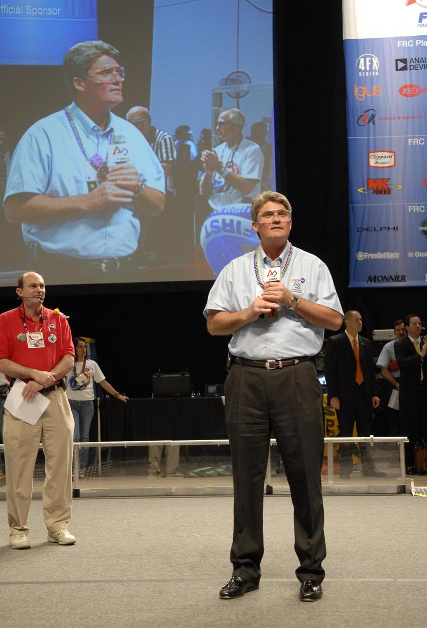 KENNEDY SPACE CENTER, FLA. --  Center Director Bill Parsons talks to an audience primarily of students during the FIRST robotics event held at the University of Central Florida Arena March 8-10.  This was Parsons' first year attending the event as center director. An alumnus of UCF, Parsons also serves on the FIRST Executive Advisory Board.  The FIRST, or For Inspiration and Recognition of Science and Technology, Robotics Competition challenges teams of young people and their mentors to solve a common problem in a six-week timeframe using a standard "kit of parts" and a common set of rules. Teams build robots from the parts and enter them in a series of competitions designed by FIRST founder Dean Kamen and Dr. Woodie Flowers, chairman and vice chairman of the Executive Advisory Board respectively, and a committee of engineers and other professionals. FIRST redefines winning for these students. Teams are rewarded for excellence in design, demonstrated team spirit, gracious professionalism and maturity, and ability to overcome obstacles. Scoring the most points is a secondary goal. Winning means building partnerships that last. Photo credit: NASA/Kim Shiflett