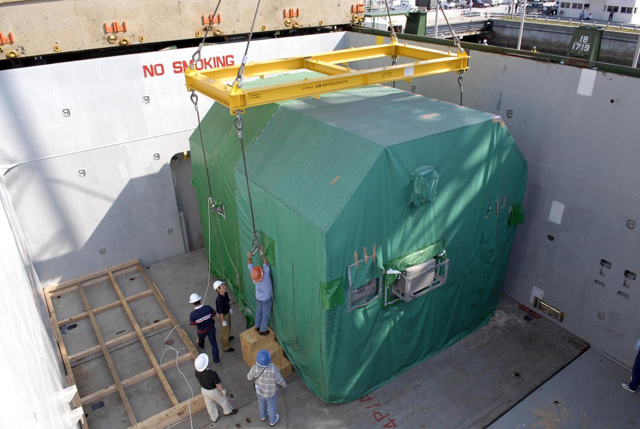KENNEDY SPACE CENTER, FLA. -- At the Trident wharf, workers in the hold of a ship attach a crane to the shipping container with the Experiment Logistics Module Pressurized Section for the Japanese Experiment Module. The ship brought the module from Yokohama, Japan. The logistics module will be offloaded and transported to the Space Station Processing Facility at NASA's Kennedy Space Center. The Japanese Experiment Module is composed of three segments and is known as Kibo, which means "hope" in Japanese. Kibo consists of six components: two research facilities -- the Pressurized Module and Exposed Facility; a Logistics Module attached to each of them; a Remote Manipulator System; and an Inter-Orbit Communication System unit. Kibo also has a scientific airlock through which experiments are transferred and exposed to the external environment of space. Kibo is Japan's first human space facility and its primary contribution to the station. Kibo will enhance the unique research capabilities of the orbiting complex by providing an additional environment in which astronauts can conduct science experiments. The various components of JEM will be assembled in space over the course of three Space Shuttle missions. The first of those three missions, STS-123, will carry the Experiment Logistics Module Pressurized Section aboard the Space Shuttle Endeavour, targeted for launch in 2007. Photo credit: NASA/Kim Shiflett