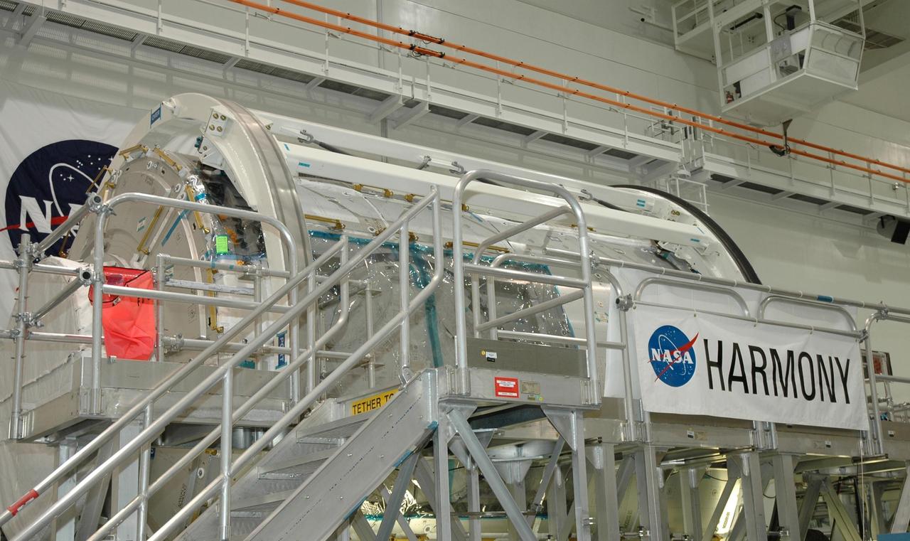 KENNEDY SPACE CENTER, FLA. --  NASA Node 2 module sits inside the Space Station Processing Facility highbay with its new name, Harmony, revealed. The name, Harmony, was chosen from an academic competition involving thousands of students in kindergarten through high school. The Node 2 Challenge required students to learn about the International Space Station, build a scale model of the module, and write an essay explaining their proposed name. This will be the first U.S. piece of the space station named by someone other than a NASA official.  Node 2 is a pressurized module that will act as a connecting port and passageway to additional international science labs and supply spacecraft. It also will be a work platform for the station's robotic arm. The module is scheduled to fly on mission STS-120 aboard Space Shuttle Atlantis targeted for later this year.   Photo credit: NASA/Jim Grossmann
