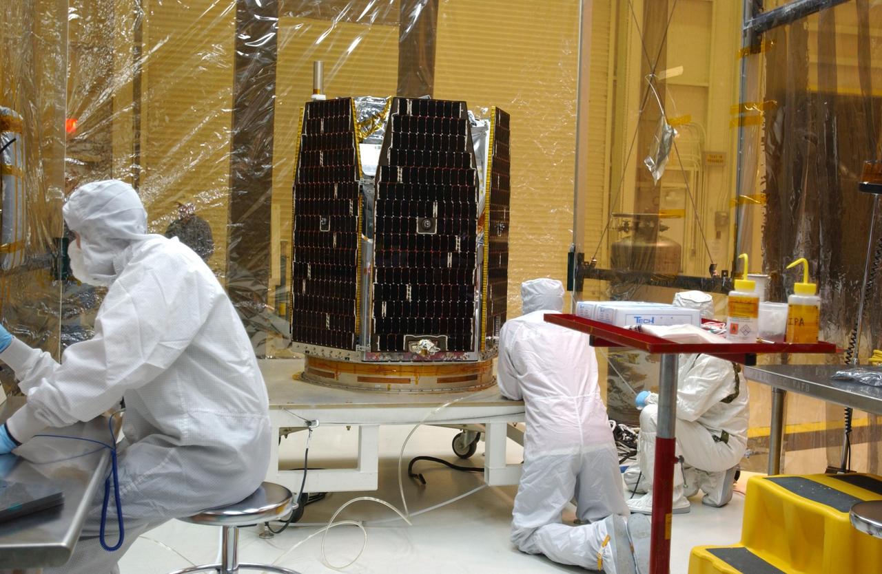 VANDENBERG AIR FORCE BASE, CALIF. -- Inside the clean-room "tent" of Building 1555 at North Vandenberg Air Force Base, technicians in bunny suits prepare for the solar array deployment on the AIM spacecraft. The AIM spacecraft will fly three instruments designed to study polar mesospheric clouds located at the edge of space, 50 miles above the Earth's surface in the coldest part of the planet's atmosphere. The mission's primary goal is to explain why these clouds form and what has caused them to become brighter and more numerous and appear at lower latitudes in recent years. AIM's results will provide the basis for the study of long-term variability in the mesospheric climate and its relationship to global climate change. AIM is scheduled to be mated to the Pegasus XL during the second week of April, after which final inspections will be conducted. Launch is scheduled for April 25.