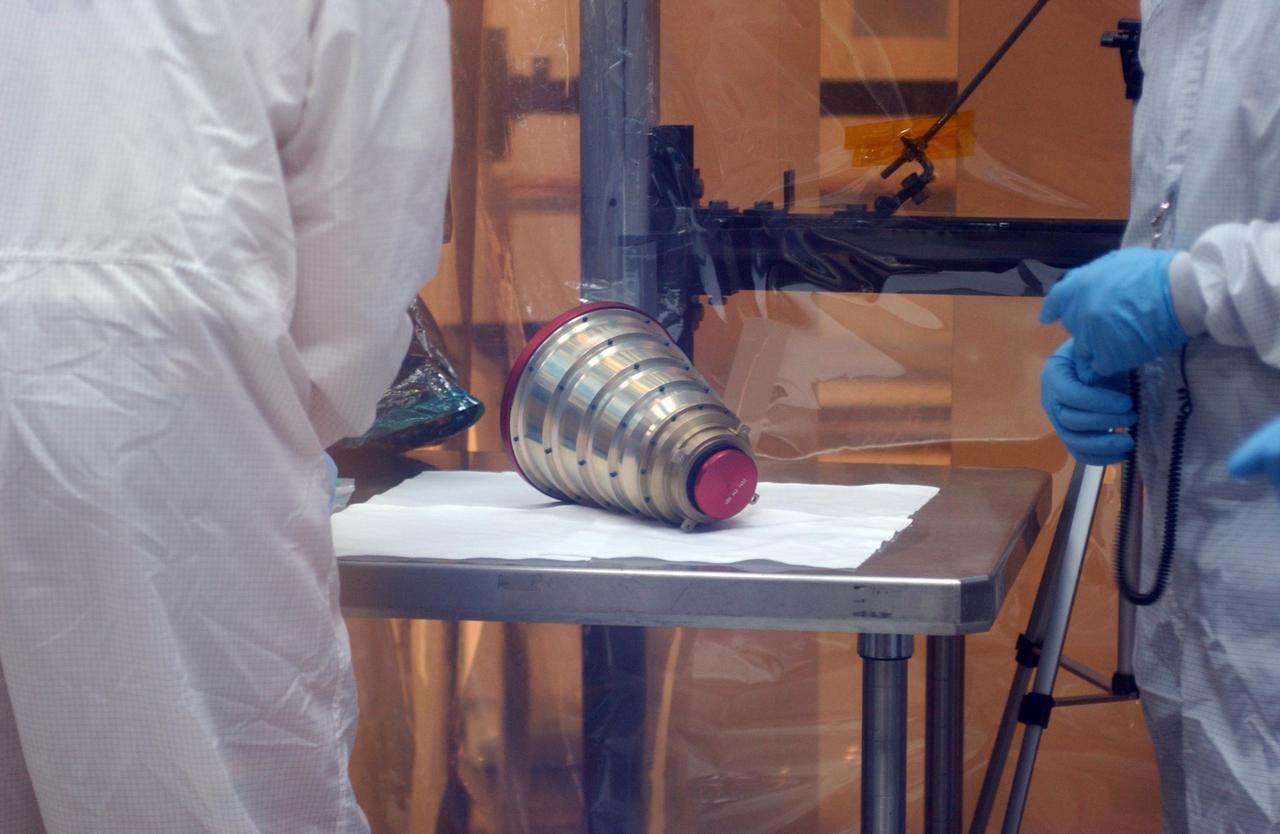 KENNEDY SPACE CENTER, FLA.  --  Inside the clean-room "tent" of Building 1555 at North Vandenberg Air Force Base, a star tracker cover is ready for placement on the AIM spacecraft during testing of the solar array panel deployment.   The AIM spacecraft will fly three instruments designed to study polar mesospheric clouds located at the edge of space, 50 miles above the Earth's surface in the coldest part of the planet's atmosphere. The mission's primary goal is to explain why these clouds form and what has caused them to become brighter and more numerous and appear at lower latitudes in recent years. AIM's results will provide the basis for the study of long-term variability in the mesospheric climate and its relationship to global climate change. AIM is scheduled to be mated to its launch vehicle, Orbital Sciences' Pegasus XL, during the second week of April, after which final inspections will be conducted.  Launch is scheduled for April 25.
