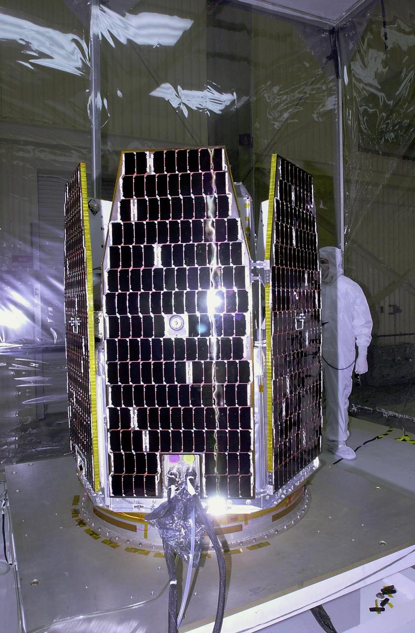 VANDENBERG AIR FORCE BASE, CALIF.  --  In a clean-room environment at North Vandenberg Air Force Base, lights are reflected on the solar array panels of the AIM spacecraft during illumination testing. The AIM spacecraft will fly three instruments designed to study those clouds located at the edge of space, 50 miles above the Earth's surface in the coldest part of the planet's atmosphere. The mission's primary goal is to explain why these clouds form and what has caused them to become brighter and more numerous and appear at lower latitudes in recent years. AIM's results will provide the basis for the study of long-term variability in the mesospheric climate and its relationship to global climate change. AIM is scheduled to be mated to the Pegasus XL during the second week of April, after which final inspections will be conducted.  Launch is scheduled for April 25.