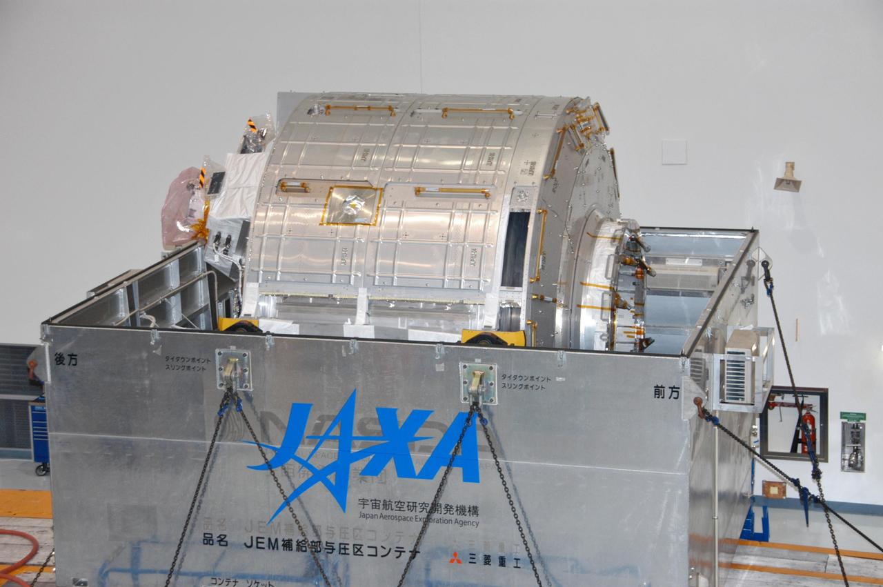 KENNEDY SPACE CENTER, FLA. --  Inside the Station Processing Facility, the Experiment Logistics Module Pressurized Section for the Japanese Experiment Module is revealed after the top of the crate is removed. The logistics module is one of the components of the Japanese Experiment Module or JEM, also known as Kibo, which means "hope" in Japanese. Kibo comprises six components: two research facilities -- the Pressurized Module and Exposed Facility; a Logistics Module attached to each of them; a Remote Manipulator System; and an Inter-Orbit Communication System unit. Kibo also has a scientific airlock through which experiments are transferred and exposed to the external environment of space. Kibo is Japan's first human space facility and its primary contribution to the station. Kibo will enhance the unique research capabilities of the orbiting complex by providing an additional environment in which astronauts can conduct science experiments. The various components of JEM will be assembled in space over the course of three Space Shuttle missions. The first of those three missions, STS-123, will carry the Experiment Logistics Module Pressurized Section aboard the Space Shuttle Endeavour, targeted for launch in 2007.   Photo credit: NASA/George Shelton