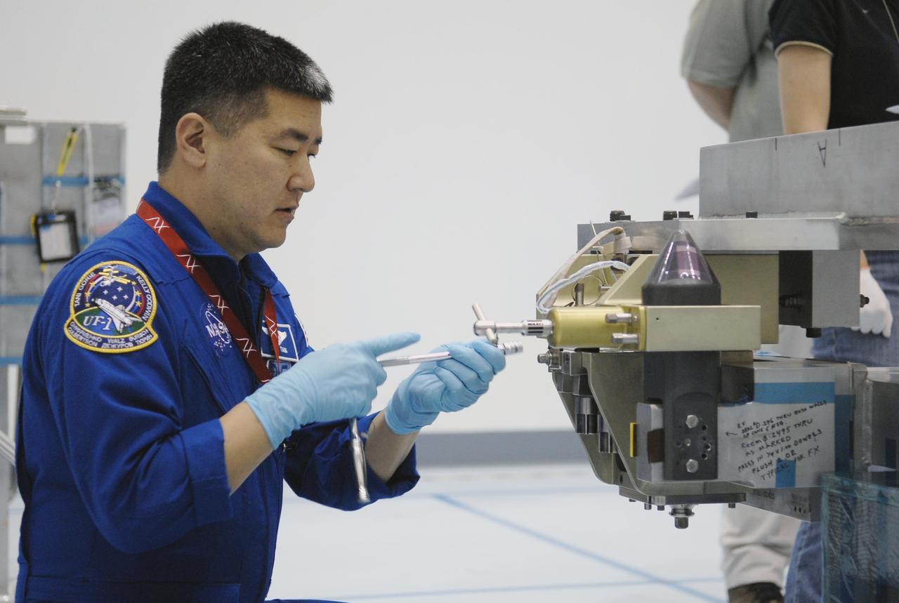 KENNEDY SPACE CENTER, FLA. --  Mission STS-120 Mission Specialist Daniel Tani familiarizes himself with  equipment inside the Space Station Processing Facility during a visit to Kennedy Space Center. Other STS-120 crew members include Commander Pam Melroy, Pilot George Zamka, and Mission Specialists Scott Parazynski, Douglas Wheelock, Stephanie Wilson, Paolo Nespoli (with the European Space Agency) and Clayton Anderson. Mission STS-120 will deliver the Node 2 "Harmony" connecting module to the station. During the mission, Tani and Anderson will transfer to the station and remain as flight engineers for Expedition 15. The mission is tentatively scheduled for August of this year. Photo credit: NASA/Kim Shiflett
