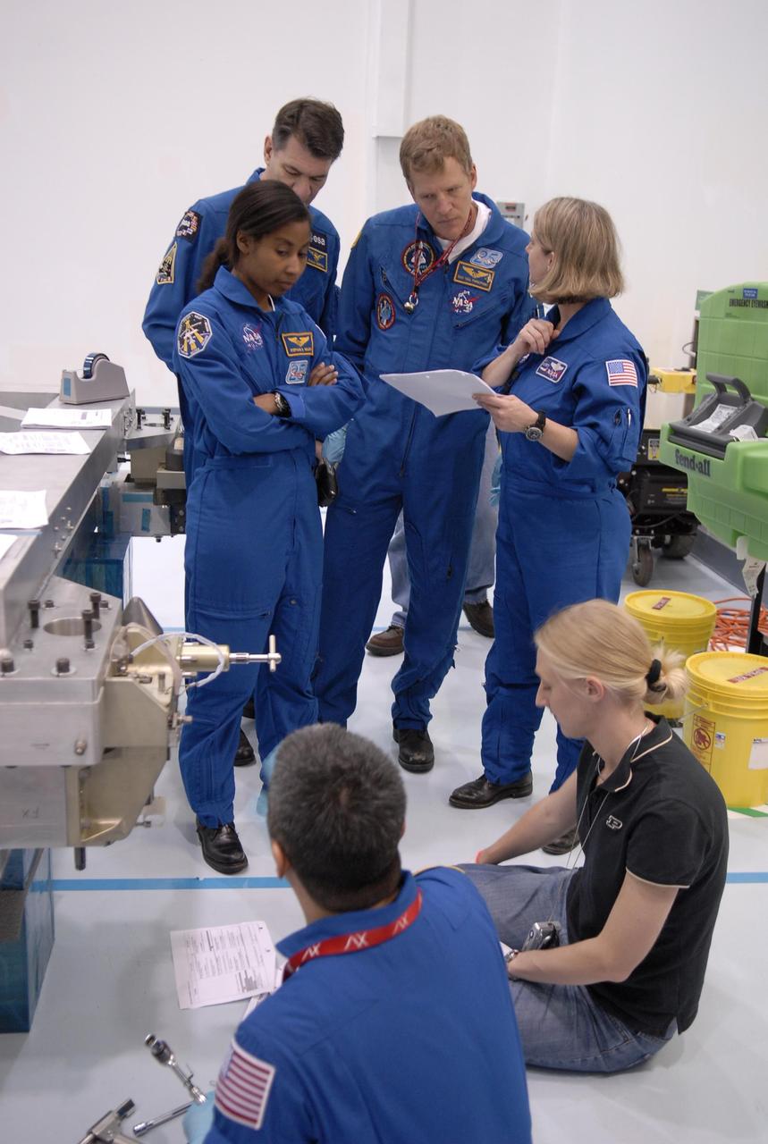 KENNEDY SPACE CENTER, FLA. --  Mission STS-120 crew members familiarize themselves with equipment inside the Space Station Processing Facility during a visit to Kennedy Space Center. Standing from left, are Mission Specialists Stephanie Wilson, Paolo Nespoli (with the European Space Agency), Scott Parazynski and Commander Pam Melroy. In the foreground at left is Mission Specialist Daniel Tani.  Other crew members include Pilot George Zamka and Mission Specialists Douglas Wheelock and Clayton Anderson.  Mission STS-120 will deliver the Node 2 "Harmony" connecting module to the station.  During the mission, Tani and Anderson will transfer to the station and remain as flight engineers for Expedition 15. The mission is tentatively scheduled for August of this year. Photo credit: NASA/Kim Shiflett