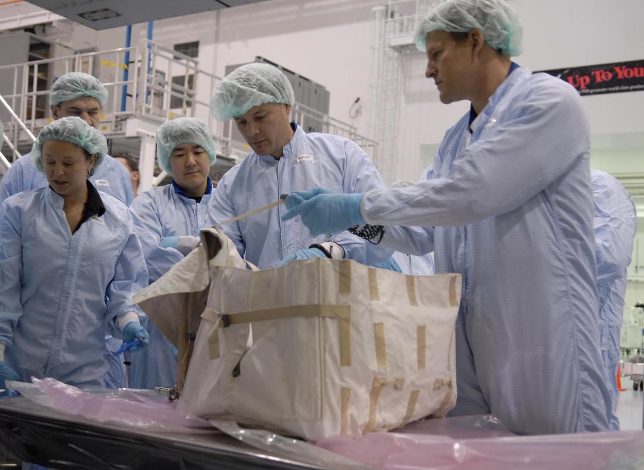 KENNEDY SPACE CENTER, FLA. --  Mission STS-120 crew members familiarize themselves with equipment inside the Space Station Processing Facility during a visit to Kennedy Space Center. From the left are Commander Pam Melroy and Mission Specialists Paolo Nespoli (with the European Space Agency), Daniel Tani, Douglas Wheelock and Scott Parazynski. Other crew members include Pilot George Zamka and Mission Specialists Stephanie Wilson and Clayton Anderson.  Mission STS-120 will deliver the Node 2 "Harmony" connecting module to the station.  During the mission, Tani and Anderson will transfer to the station and remain as flight engineers for Expedition 15. The mission is tentatively scheduled for August of this year. Photo credit: NASA/Kim Shiflett