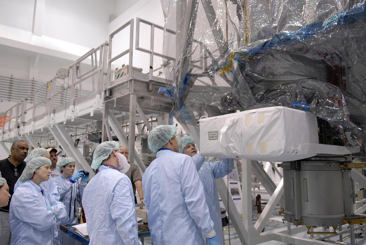 KENNEDY SPACE CENTER, FLA. -- Inside the Space Station Processing Facility, mission STS-120 crew members familiarize themselves with equipment during a visit to Kennedy Space Center. Crew members are Commander Pam Melroy, Pilot George Zamka and Mission Specialists Scott Parazynski, Douglas Wheelock, Stephanie Wilson, Paolo Nespoli (with the European Space Agency), Daniel Tani and Clayton Anderson. Mission STS-120 will deliver the Node 2 "Harmony" connecting module to the station.  During the mission, Tani and Anderson will transfer to the station and remain as flight engineers for Expedition 15. The mission is tentatively scheduled for August of this year. Photo credit: NASA/Kim Shiflett