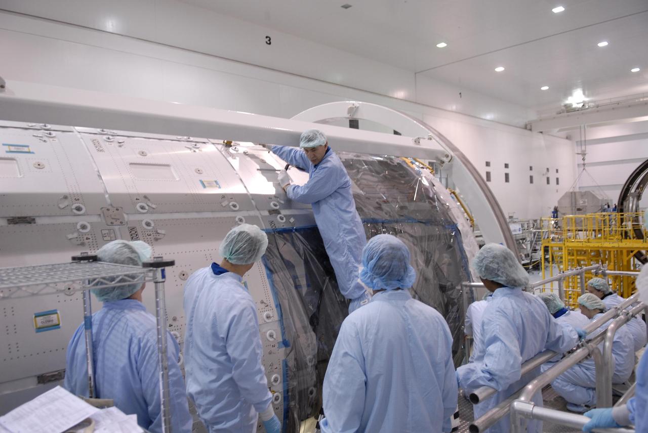 KENNEDY SPACE CENTER, FLA. -- Mission STS-120 crew members familiarize themselves with equipment and payloads inside the Space Station Processing Facility during a visit to Kennedy Space Center. Standing in front of the Node 2 Harmony module is Paolo Nespoli, who is with the European Space Agency. Other STS-120 crew members include Commander Pam Melroy, Pilot George Zamka and Mission Specialists Scott Parazynski, Douglas Wheelock, Stephanie Wilson, Daniel Tani and Clayton Anderson. Mission STS-120 will deliver the Node 2 "Harmony" connecting module to the station.  During the mission, Tani and Anderson will transfer to the station and remain as flight engineers for Expedition 15. The mission is tentatively scheduled for August of this year. Photo credit: NASA/Kim Shiflett