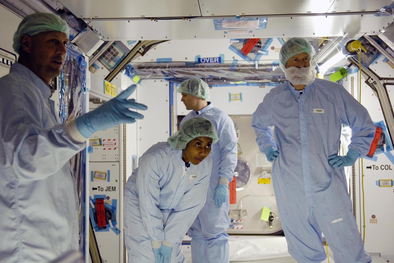 KENNEDY SPACE CENTER, FLA. -- Mission STS-120 crew members familiarize themselves with equipment and payloads inside the Space Station Processing Facility during a visit to Kennedy Space Center. Standing inside the Node 2 Harmony module are (from left) Mission Specialists Clayton Anderson and Stephanie Wilson. Other crew members include Commander Pam Melroy, Pilot George Zamka and Mission Specialists Scott Parazynski, Douglas Wheelock, Daniel Tani, Paolo Nespoli (with the European Space Agency) and Clayton Anderson.  Mission STS-120 will deliver the Node 2 "Harmony" connecting module to the station.  During the mission, Tani and Anderson will transfer to the station and remain as flight engineers for Expedition 15. The mission is tentatively scheduled for August of this year. Photo credit: NASA/Kim Shiflett
