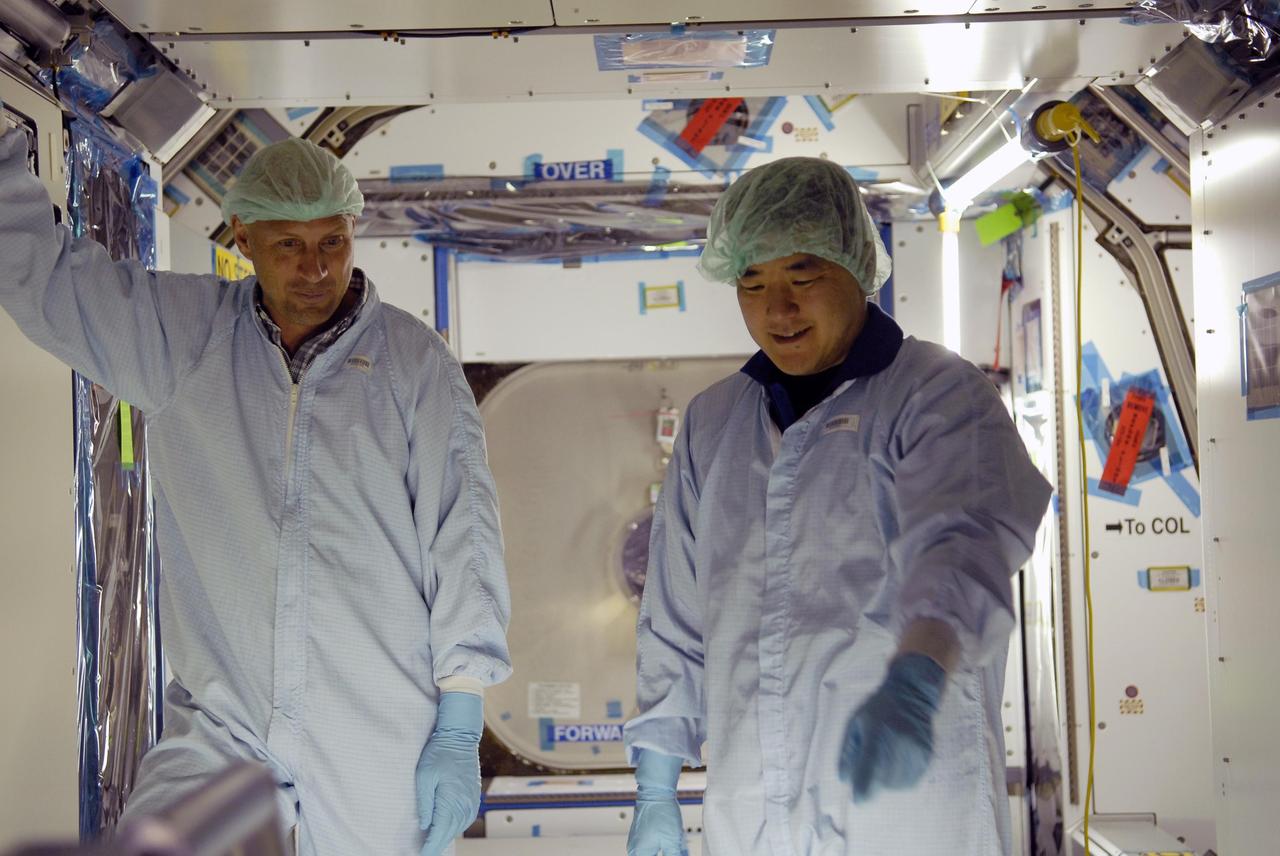 KENNEDY SPACE CENTER, FLA. -- Mission STS-120 Mission Specialists Clayton Anderson (left) and Daniel Tani familiarize themselves with the Node 2 Harmony module inside the Space Station Processing Facility during a visit to Kennedy Space Center. Other crew members include Commander Pam Melroy, Pilot George Zamka, and Mission Specialists Scott Parazynski, Douglas Wheelock, Stephanie Wilson and Paolo Nespoli (with the European Space Agency). Mission STS-120 will deliver the Node 2 "Harmony" connecting module to the station.  During the mission, Tani and Anderson will transfer to the station and remain as flight engineers for Expedition 15. The mission is tentatively scheduled for August of this year. Photo credit: NASA/Kim Shiflett