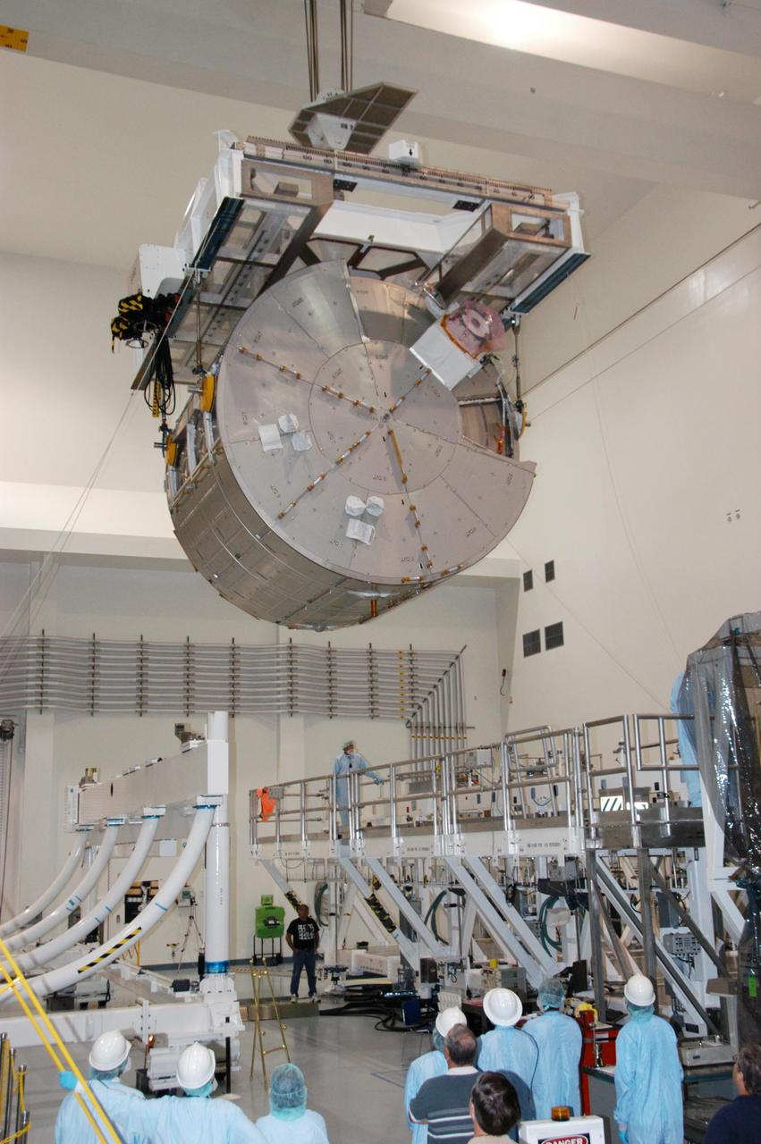 KENNEDY SPACE CENTER, FLA. -- In the Space Station Processing Facility, an overhead crane moves the JEM Experiment Logistics Module Pressurized Section toward a scale (at left) for weight and center-of-gravity measurements. The module will then be moved to a work stand. The logistics module is one of the components of the Japanese Experiment Module or JEM, also known as Kibo, which means "hope" in Japanese. Kibo comprises six components: two research facilities -- the Pressurized Module and Exposed Facility; a Logistics Module attached to each of them; a Remote Manipulator System; and an Inter-Orbit Communication System unit. Kibo also has a scientific airlock through which experiments are transferred and exposed to the external environment of space. Kibo is Japan's first human space facility and its primary contribution to the station. Kibo will enhance the unique research capabilities of the orbiting complex by providing an additional environment in which astronauts can conduct science experiments. The various components of JEM will be assembled in space over the course of three Space Shuttle missions. The first of those three missions, STS-123, will carry the Experiment Logistics Module Pressurized Section aboard the Space Shuttle Endeavour, targeted for launch in 2007. Photo credit: NASA/George Shelton