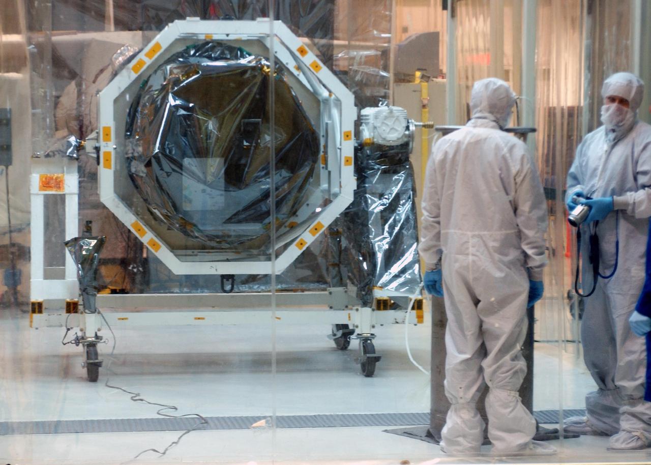 KENNEDY SPACE CENTER, FLA.  --  At North Vandenberg Air Force Base in California, the AIM spacecraft is moved into a clean room for testing.  AIM, which stands for Aeronomy of Ice in the Mesosphere, is being prepared for integrated testing and a flight simulation.  The AIM spacecraft will fly three instruments designed to study polar mesospheric clouds located at the edge of space, 50 miles above the Earth's surface in the coldest part of the planet's atmosphere. The mission's primary goal is to explain why these clouds form and what has caused them to become brighter and more numerous and appear at lower latitudes in recent years. AIM's results will provide the basis for the study of long-term variability in the mesospheric climate and its relationship to global climate change. AIM is scheduled to be mated to its launch vehicle, Orbital Sciences' Pegasus XL, during the second week of April, after which final inspections will be conducted.  Launch is scheduled for April 25.