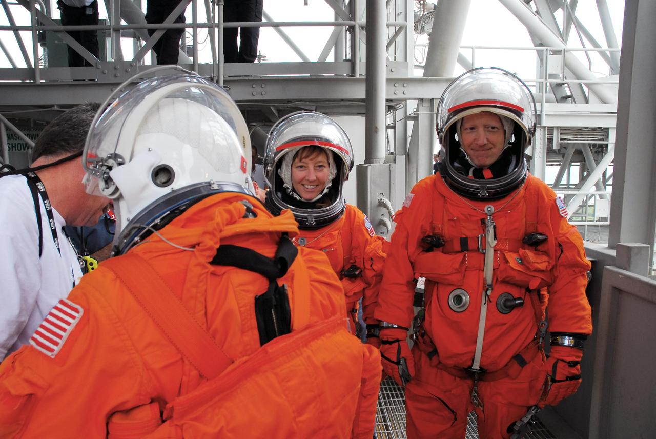 KENNEDY SPACE CENTER, FLA. -- During a simulated rescue mission on Launch Pad 39A, known as Mode 2, KSC personnel dressed in astronauts' launch-and-entry suits move from the white room on the 195-foot level toward the slidewire baskets. The KSC rescue teams are practicing emergency procedures in the unlikely scenario of a mishap on the pad during a launch sequence. The exercises are standard training procedures to assess and prepare emergency personnel, procedures and hardware. Photo credit: NASA/Jack Pfaller