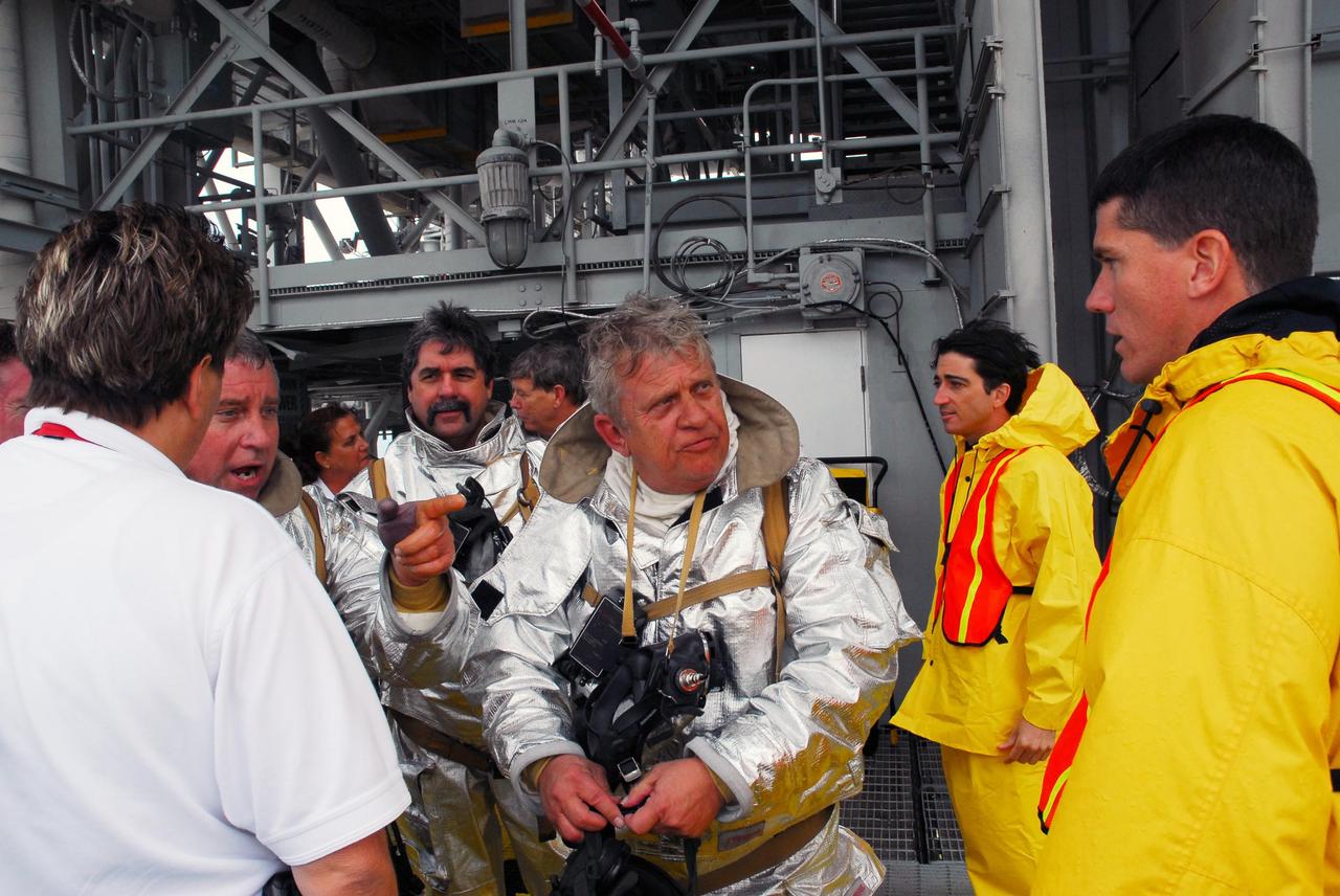 KENNEDY SPACE CENTER, FLA.  -- After a simulated rescue mission on Launch Pad 39A, the fire rescue team compares notes about the activity.  KSC workers dressed in official launch-and-entry suits portrayed astronauts. The KSC rescue teams are practicing emergency procedures in the unlikely scenario of a mishap on the pad during a launch sequence.  The exercises are standard training procedures to assess and prepare emergency personnel, procedures and hardware.  Photo credit: NASA/Jack Pfaller