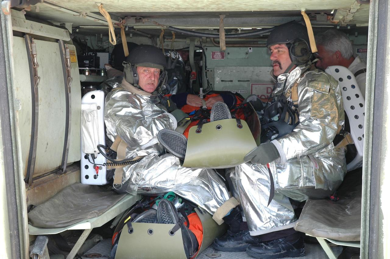 KENNEDY SPACE CENTER, FLA. -- Inside an M-113 armored personnel carrier, members of the KSC rescue team escort an "injured" astronaut, portrayed by a KSC worker, during the second stage of a simulated emergency, known as Mode 4. The M-113 will be used to transport the worker to a triage area. The emergency exercise began at the 195-foot level of Launch Pad 39A. The KSC rescue teams are practicing emergency procedures in the unlikely scenario of a mishap on the pad during a launch sequence. The exercises are standard training procedures to assess and prepare emergency personnel, procedures and hardware. Photo credit: NASA/Jim Grossmann